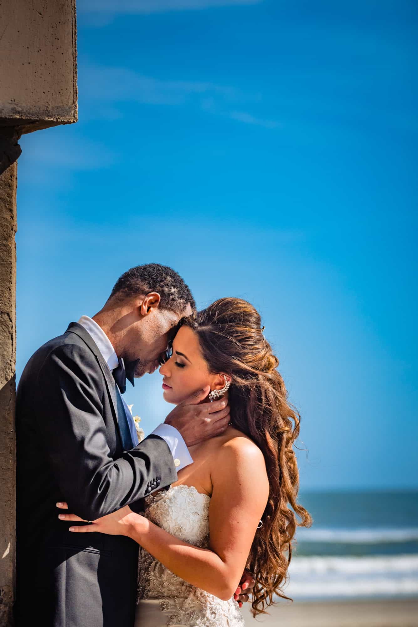 the bride and groom portrait taken along the beach