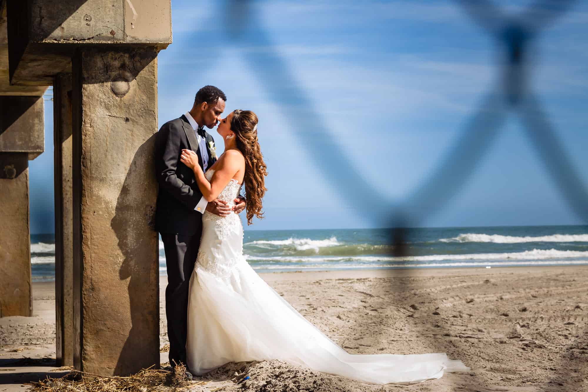 the bride and groom portrait taken along the beach