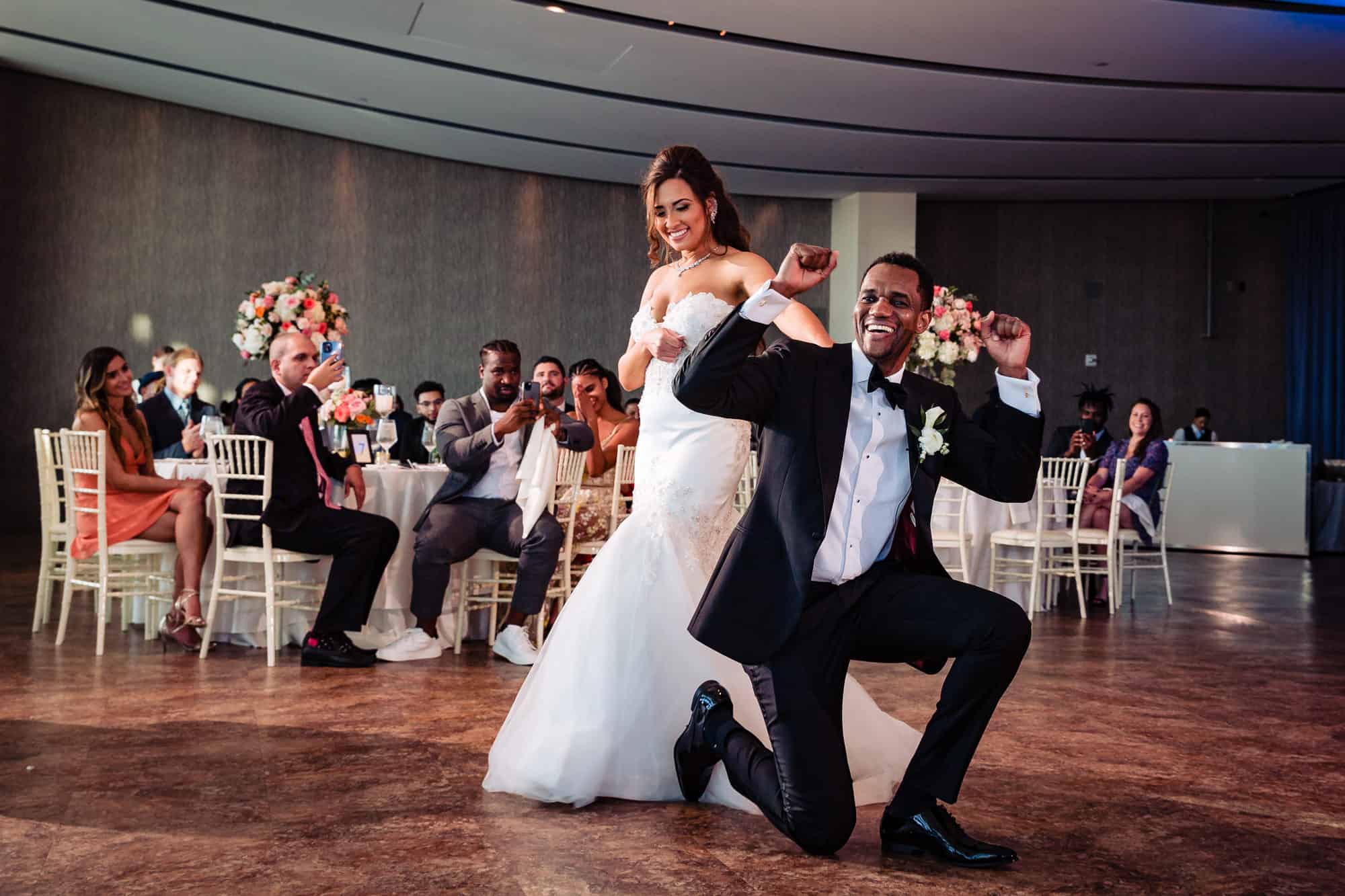 the newlyweds having fun on the floor at One Atlantic reception