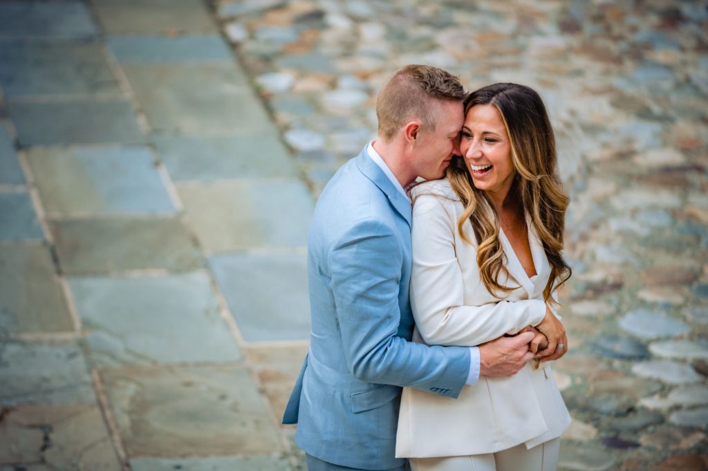 couple embracing and smiling during their philly summer e-session
