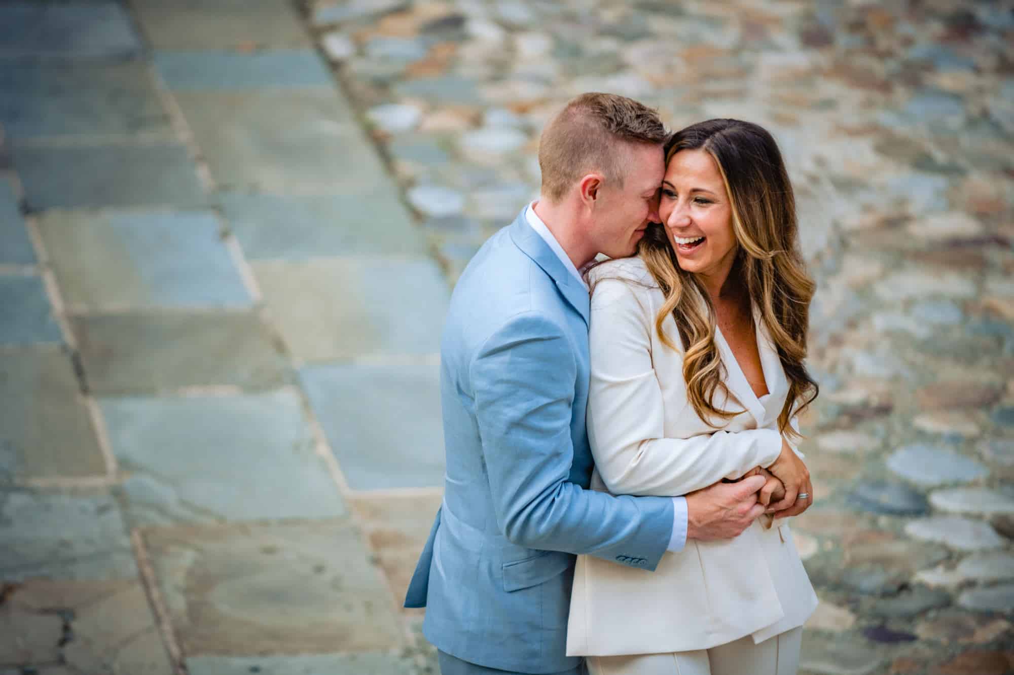 couple embracing and smiling during their philly summer e-session