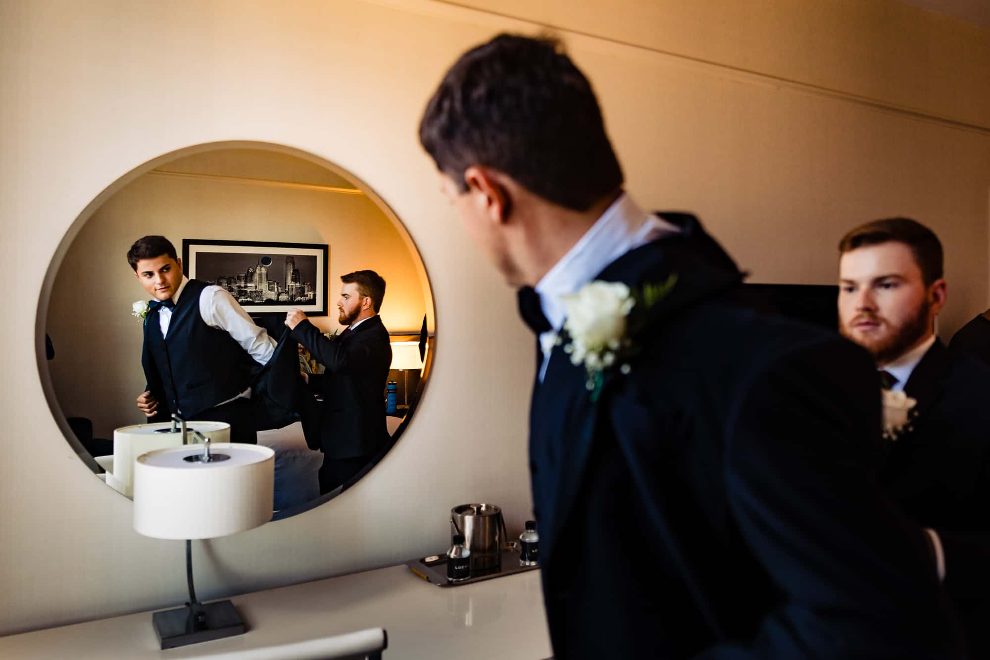 groom is getting ready with the help of his bestman