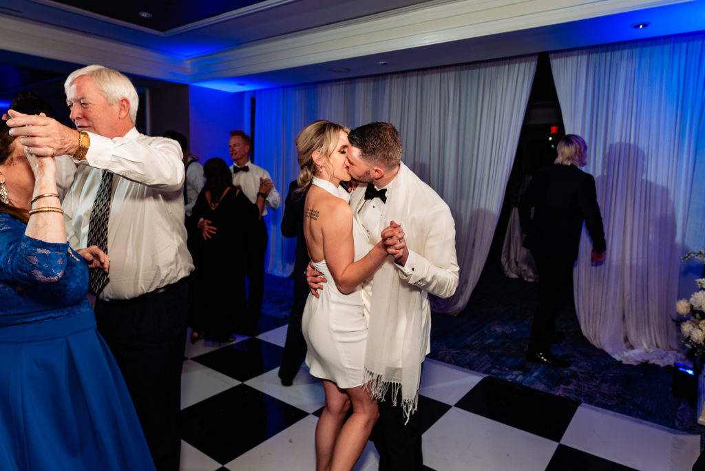the newlyweds kissing on the dance floor
