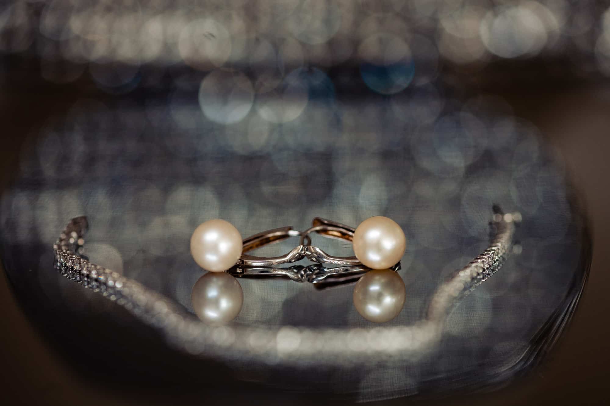 wedding accessories such as a bracelet and a pearl earrings