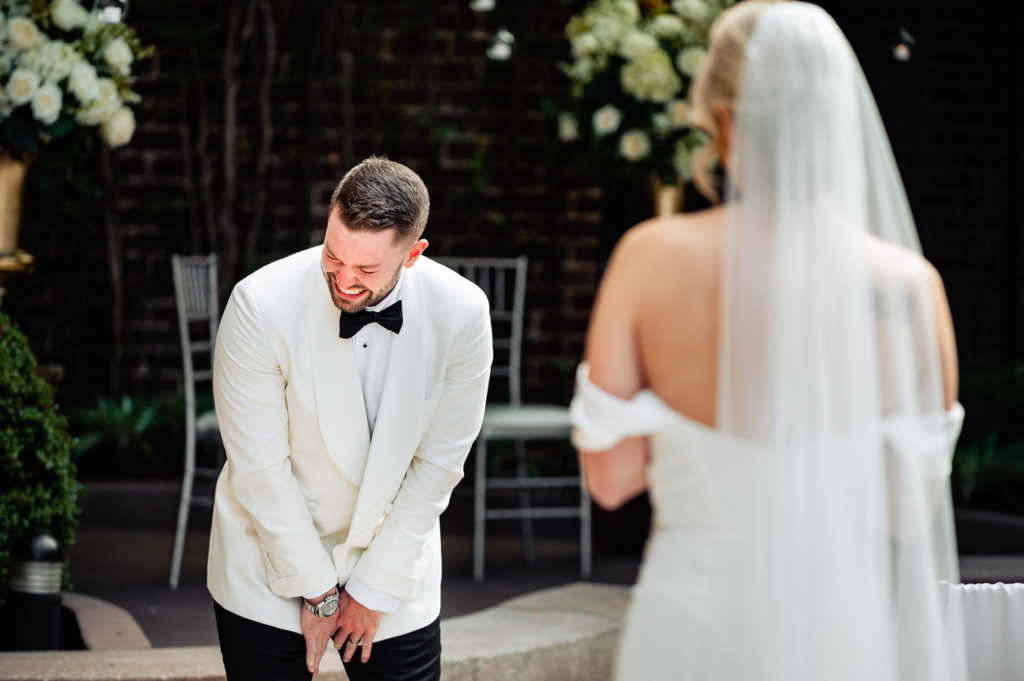 groom is ecstatic for his first look at her bride