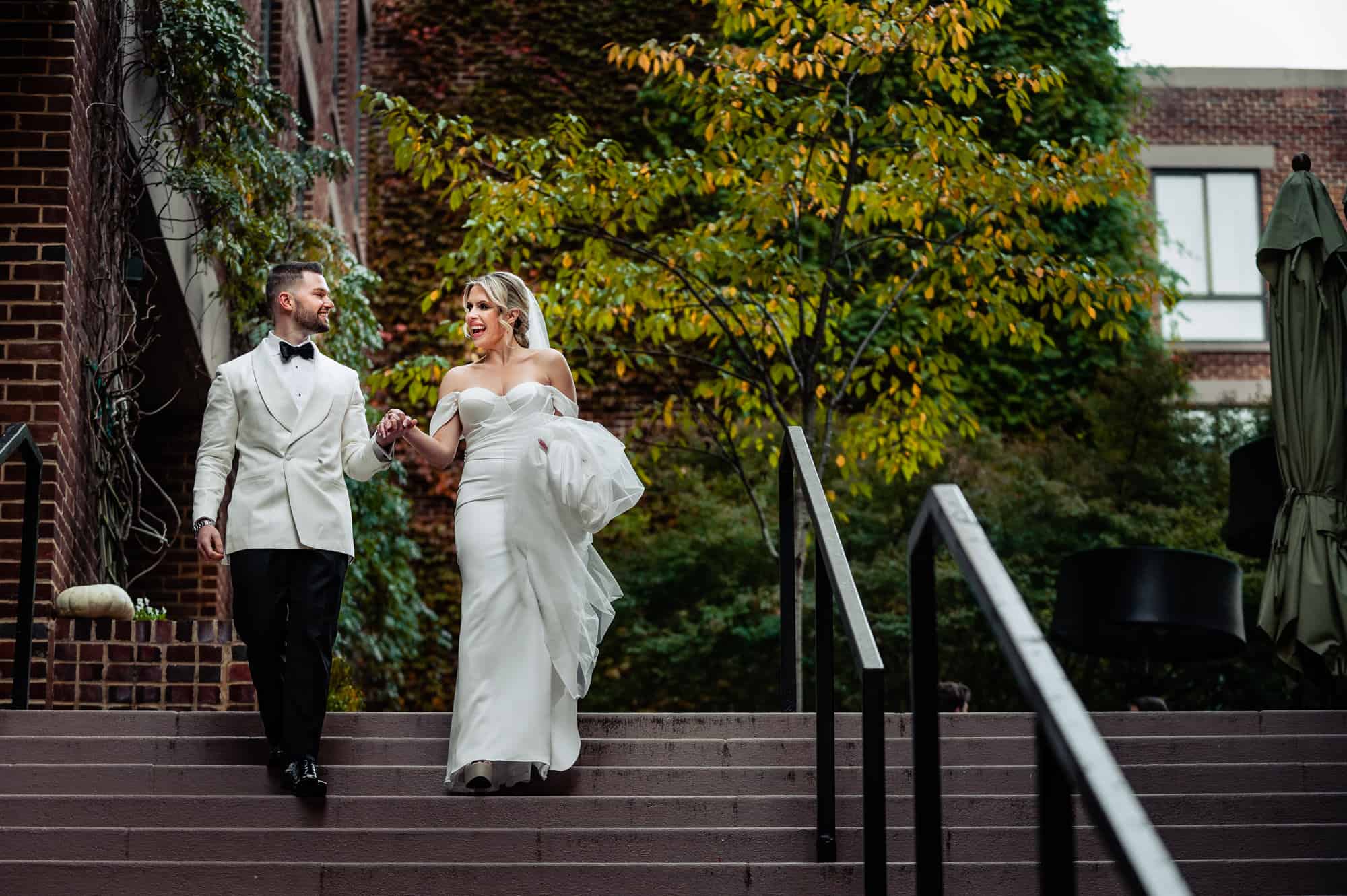 bride and groom walking down the stairs