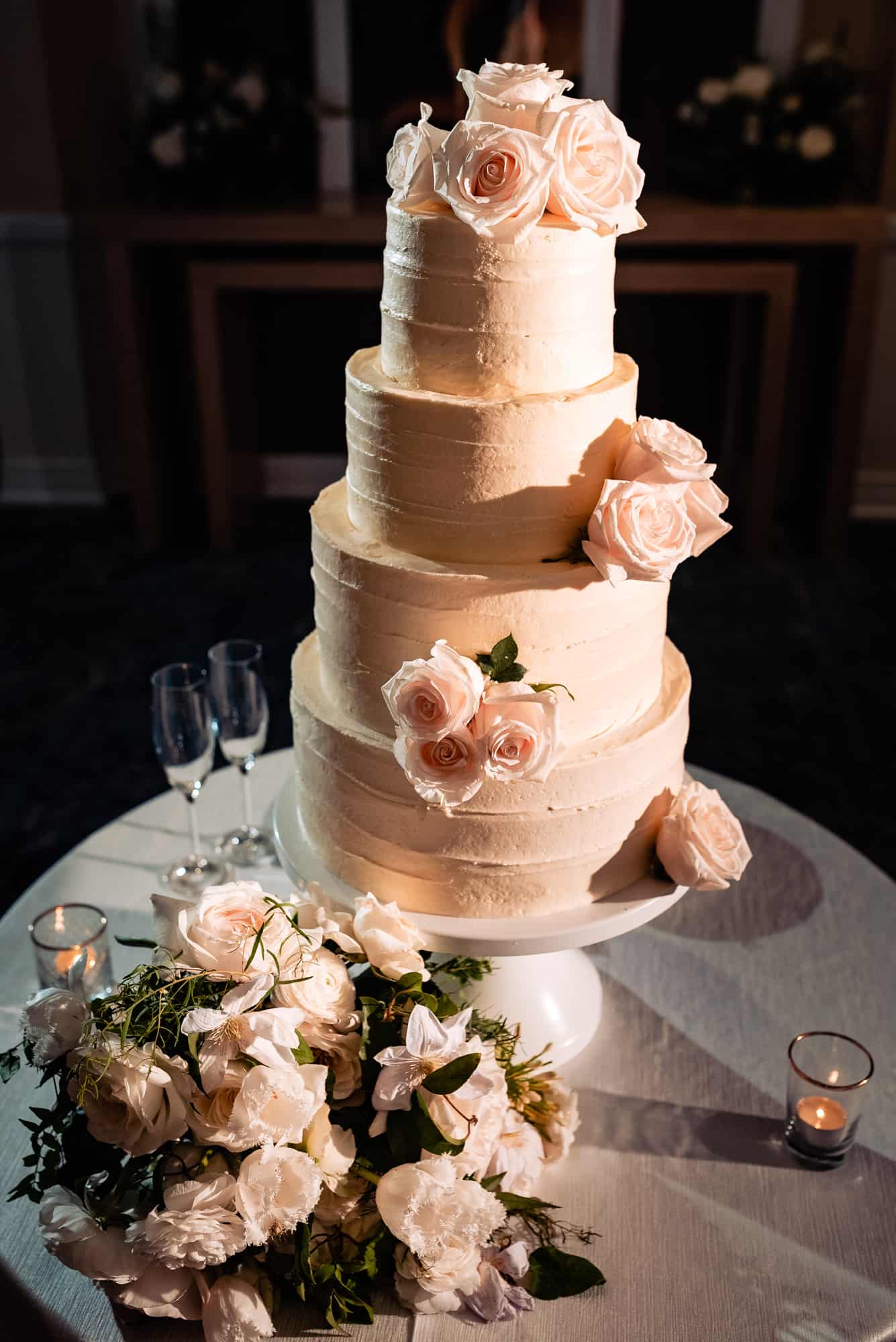 four tiered cake with rose accents