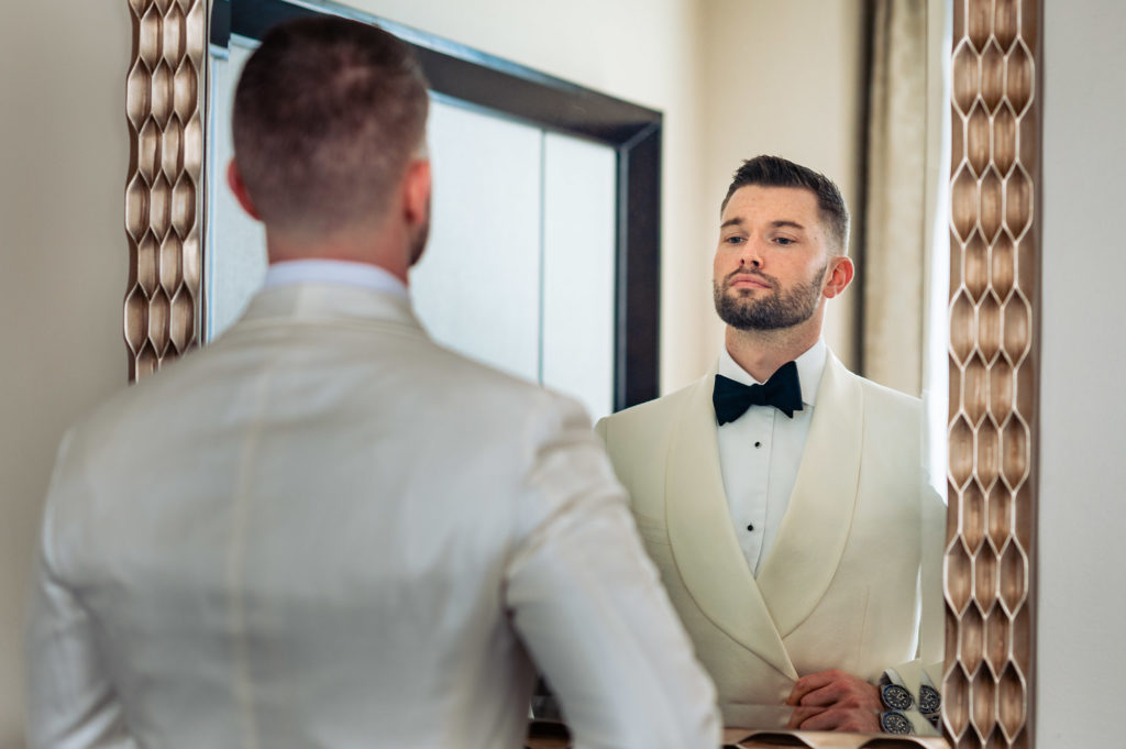 groom looking at the mirror