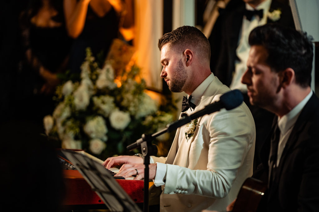 two men singing during a wedding