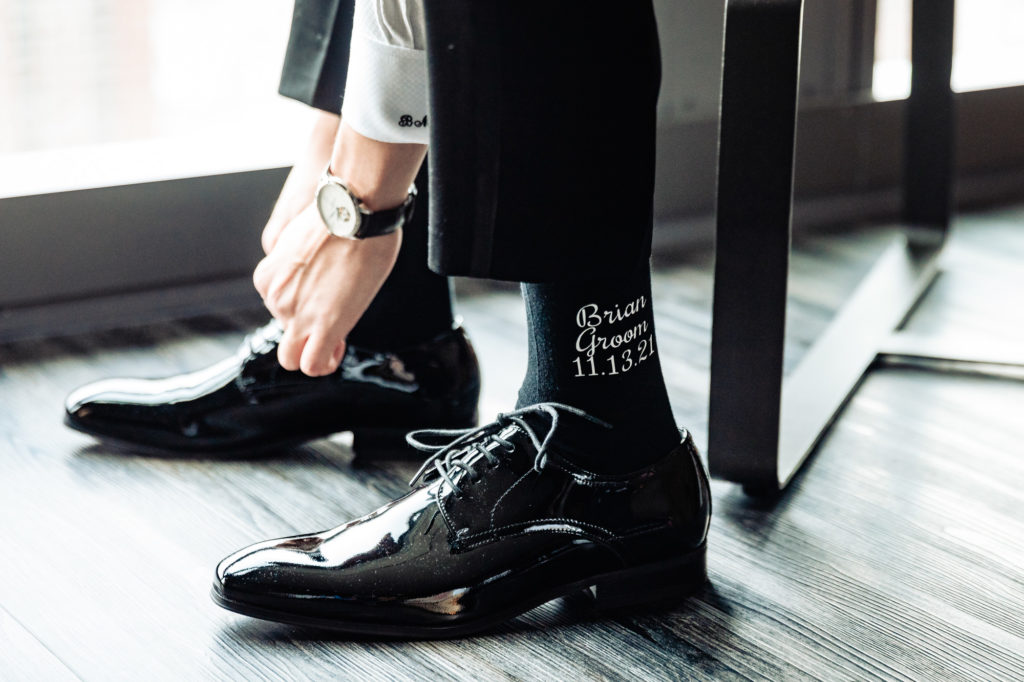 groom tying his shoes for the wedding