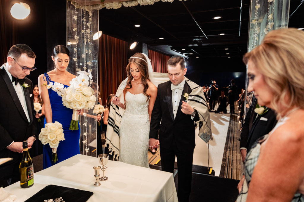 bride and groom in prayer during their W Hotel Philly ceremony