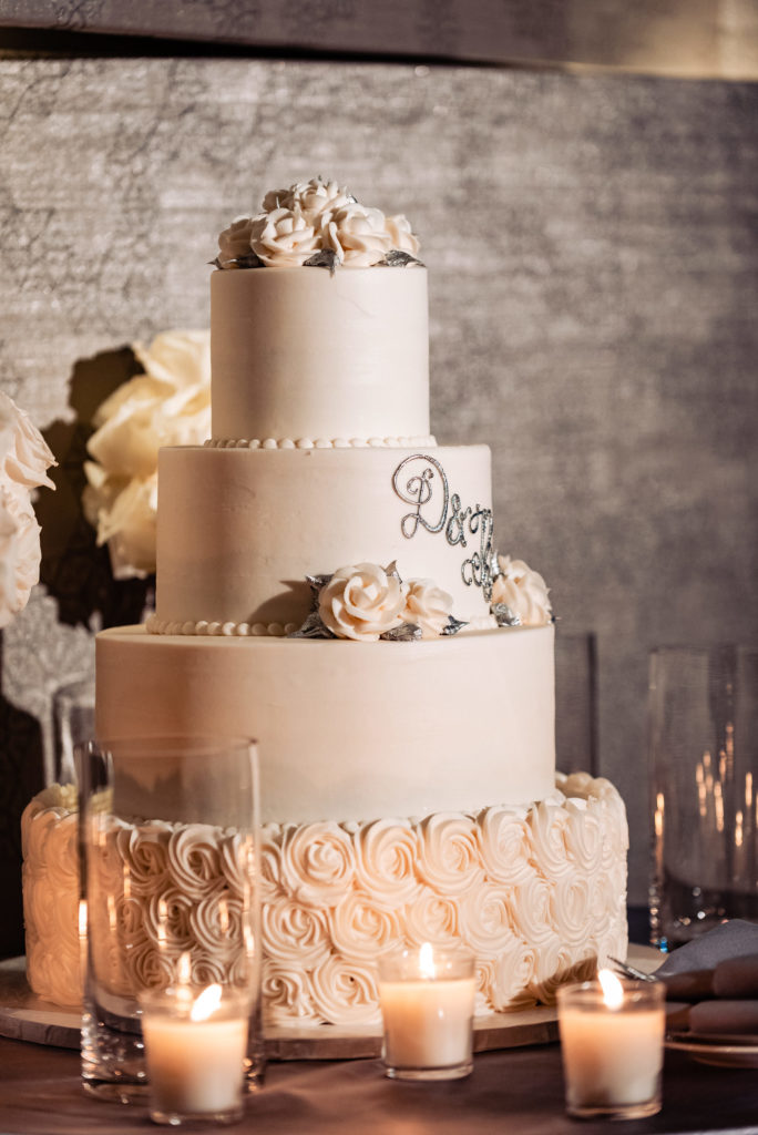 four tiered cake with rose accents