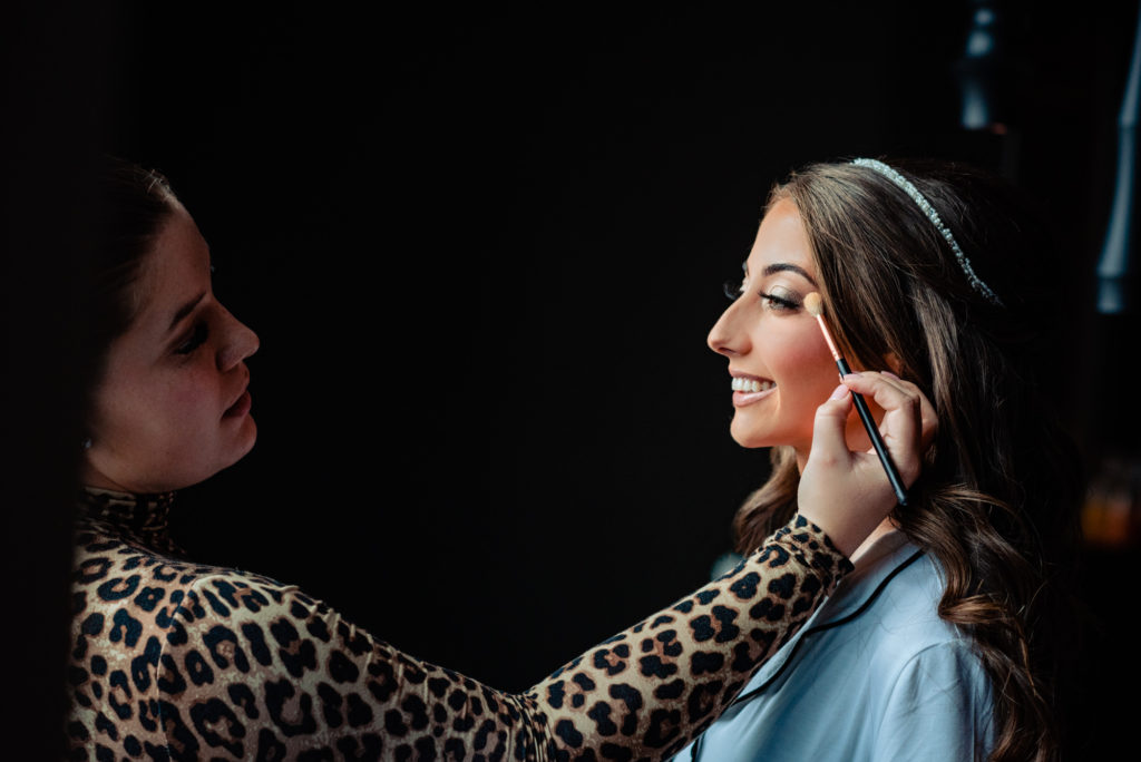 bride getting her makeup done at a W Hotel Philly wedding