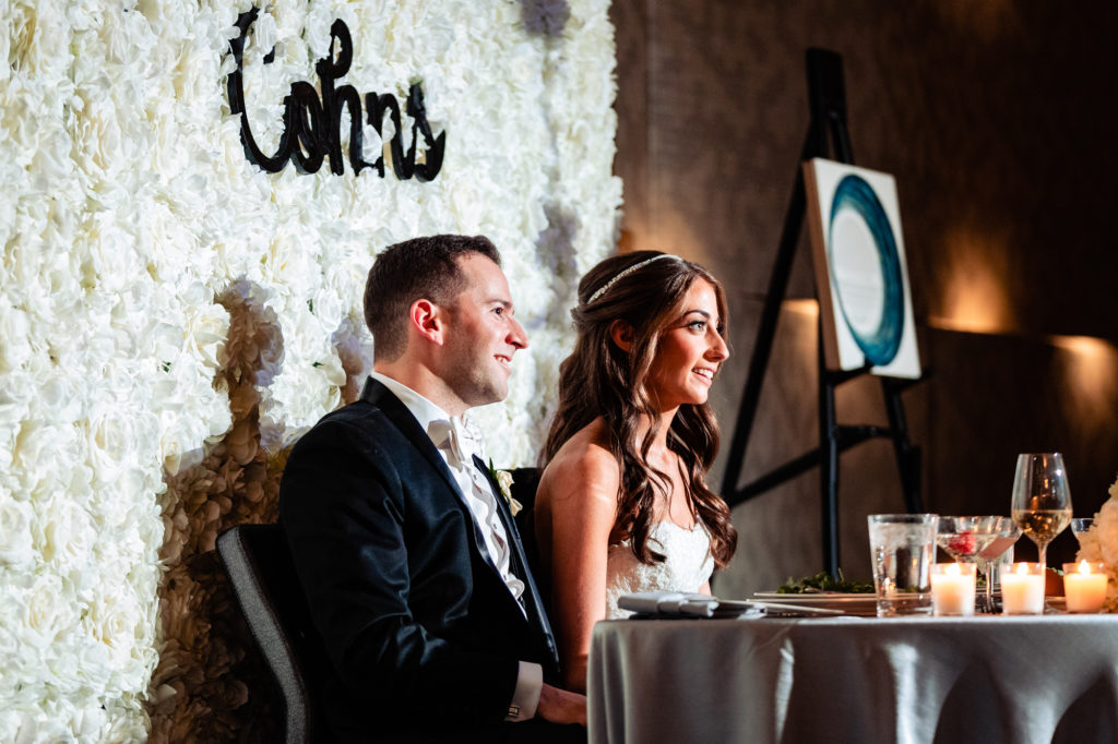 bride and groom smiling during toasts at their W Hotel Philly wedding