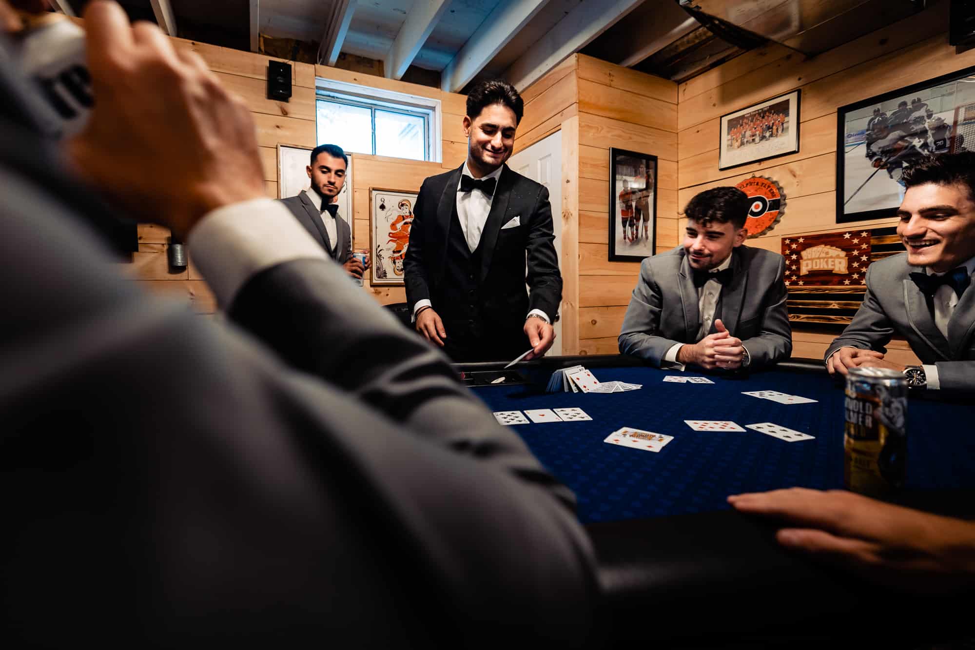 groom is playing cards with his entourage