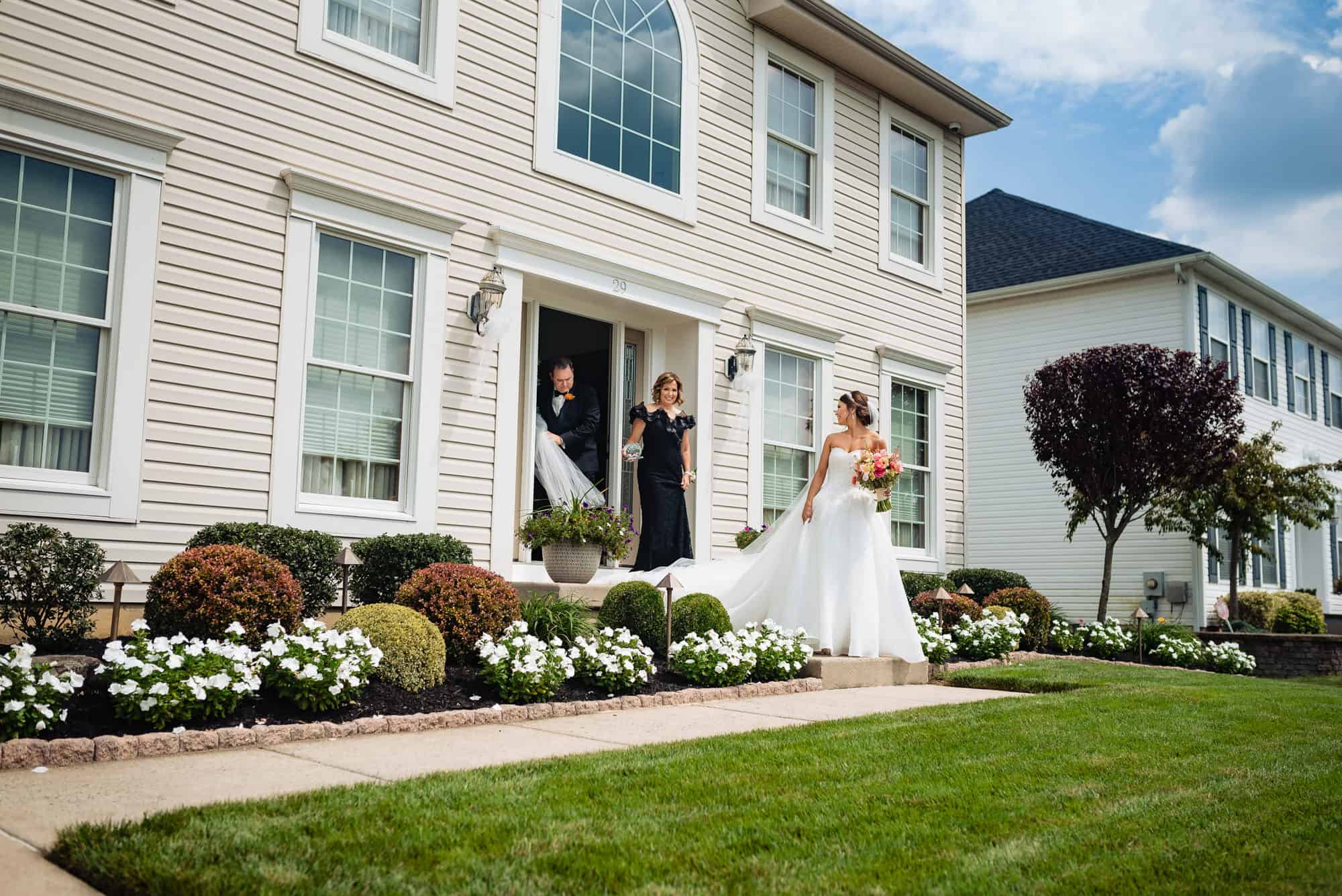 bride standing outside her parents house before going to her wedding