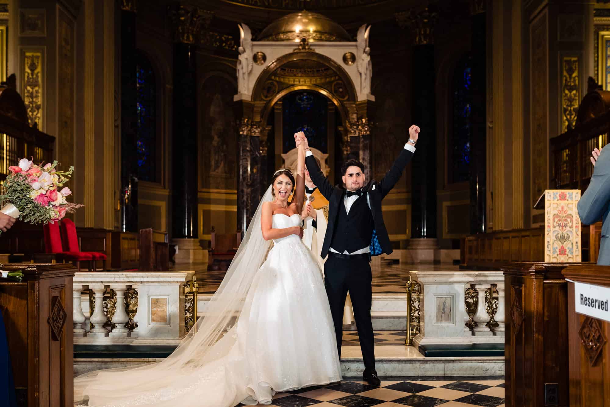 the newlyweds with smiles on their faces after the first kiss