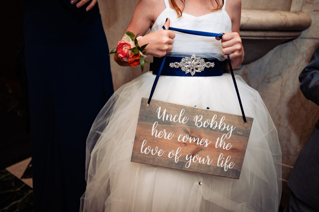 flower girl holding a signage