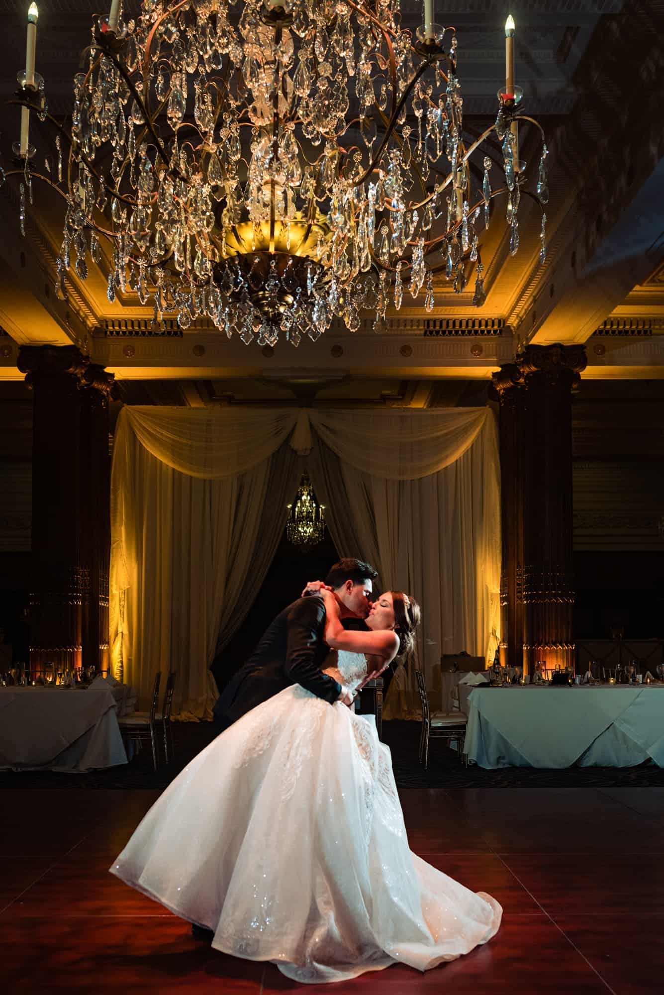 the newlyweds kissing on the dance floor