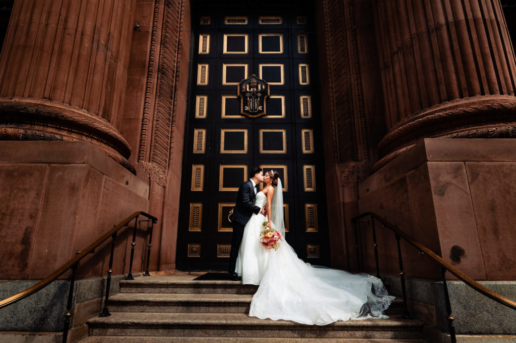 bride and groom kissing outside the church