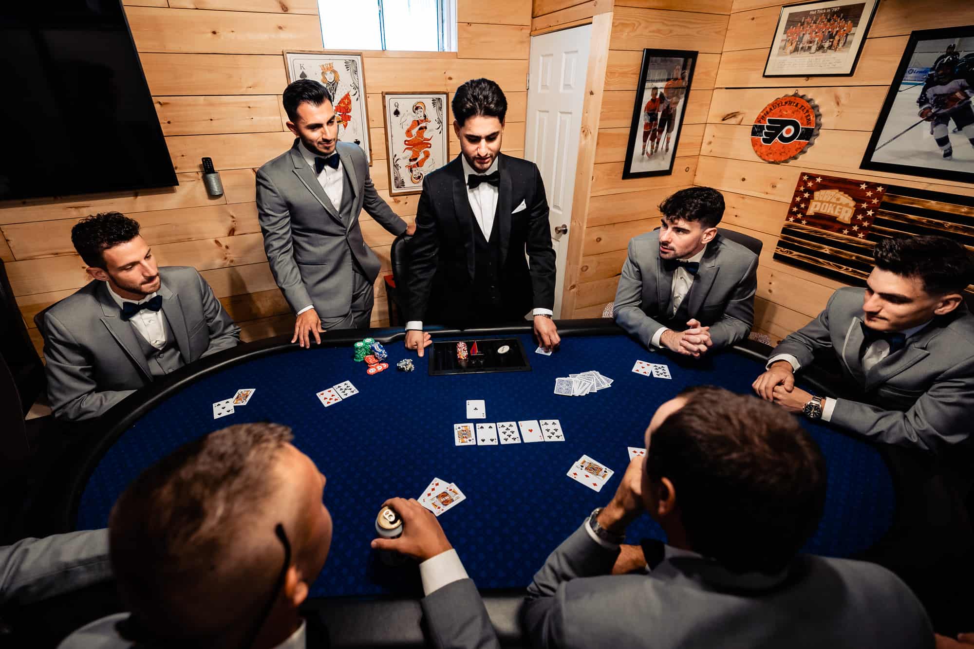 groom is playing cards with his entourage