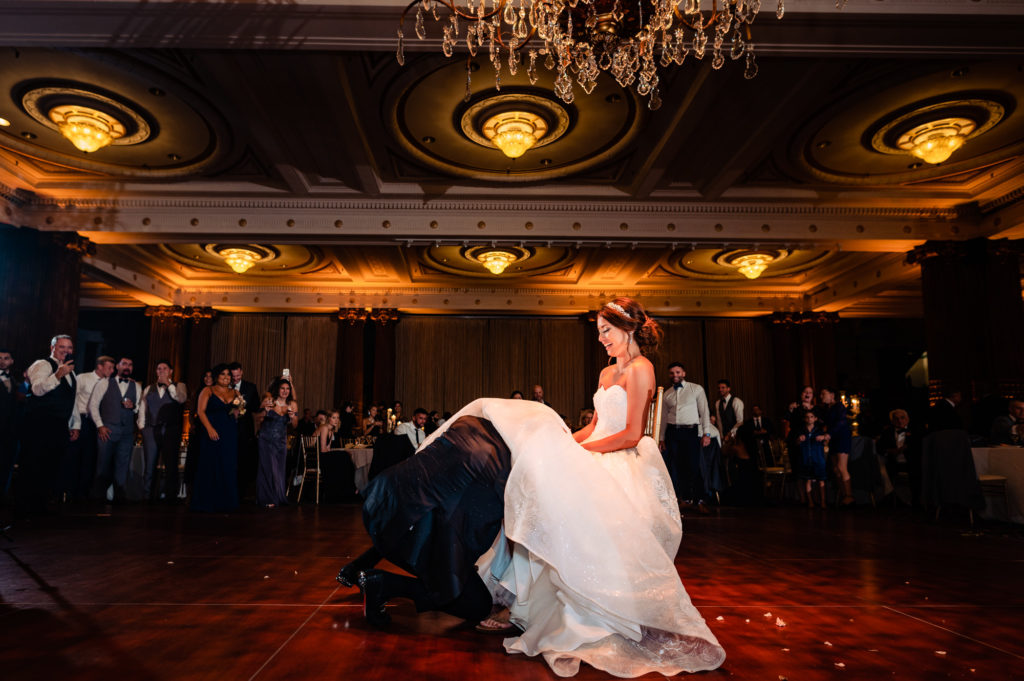 groom removing the garter from his bride