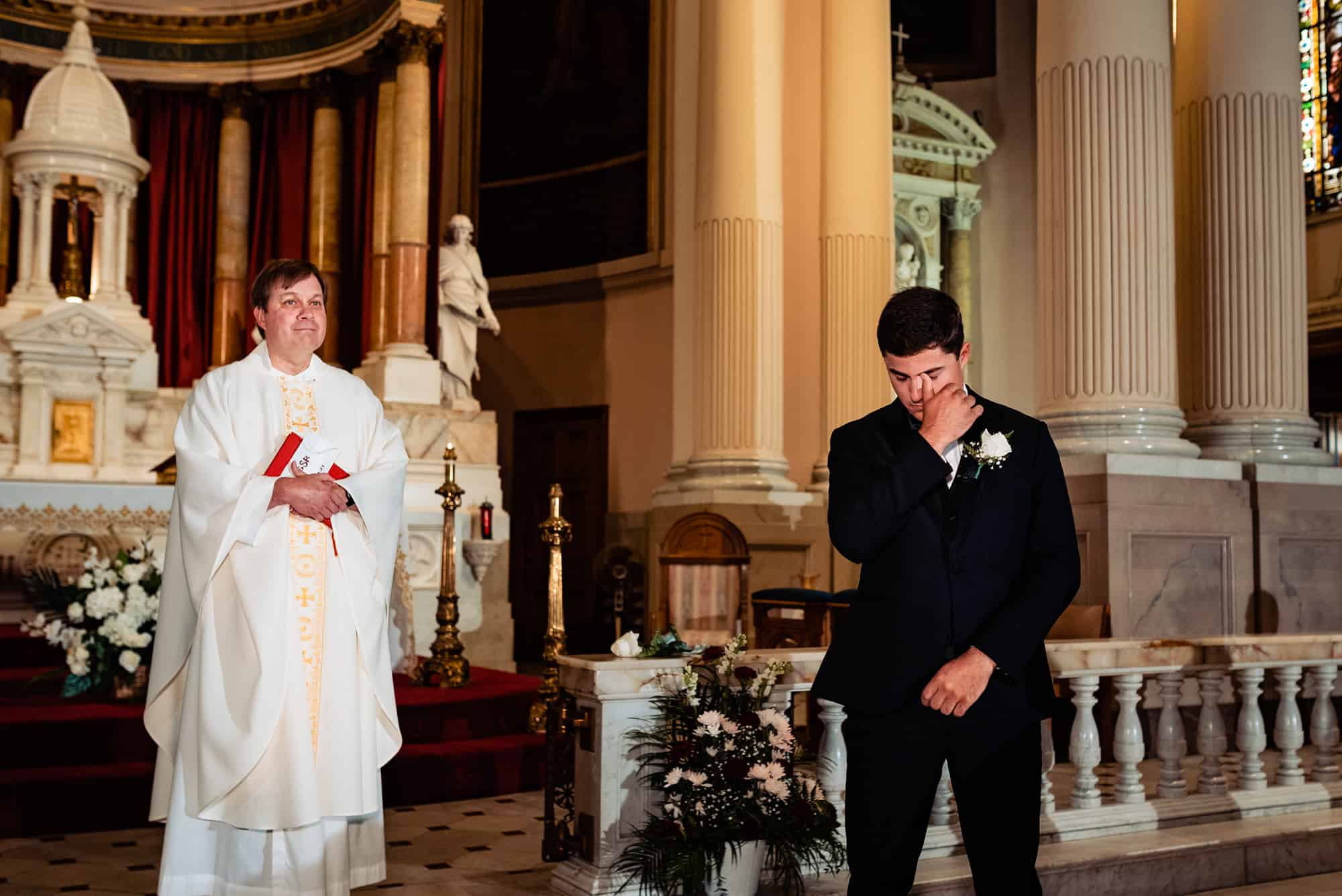 a teary-eyed groom waiting at the altar