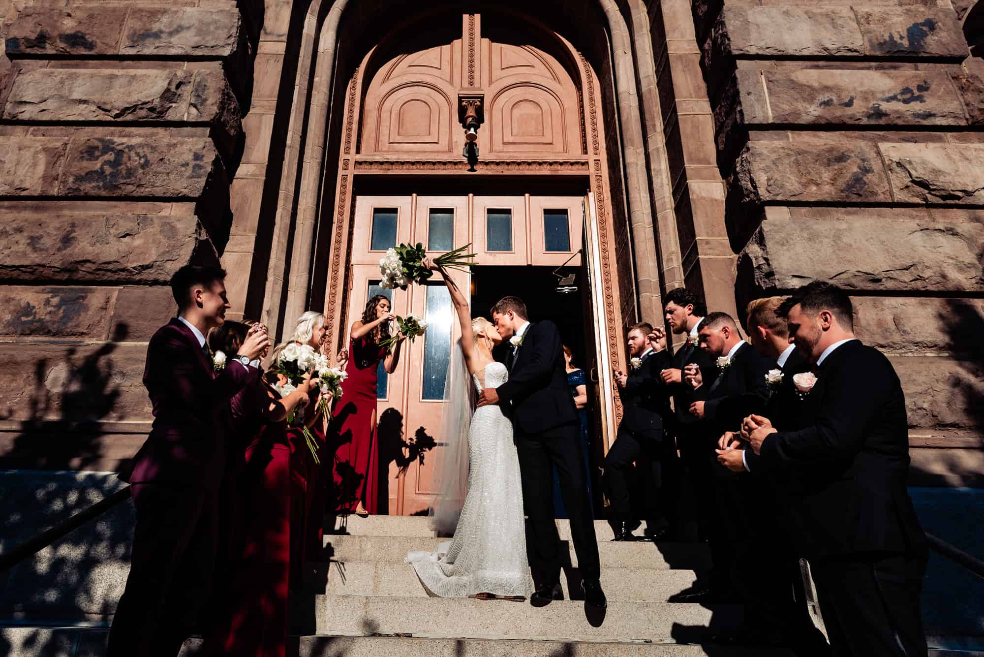 newlyweds kissing outside the church