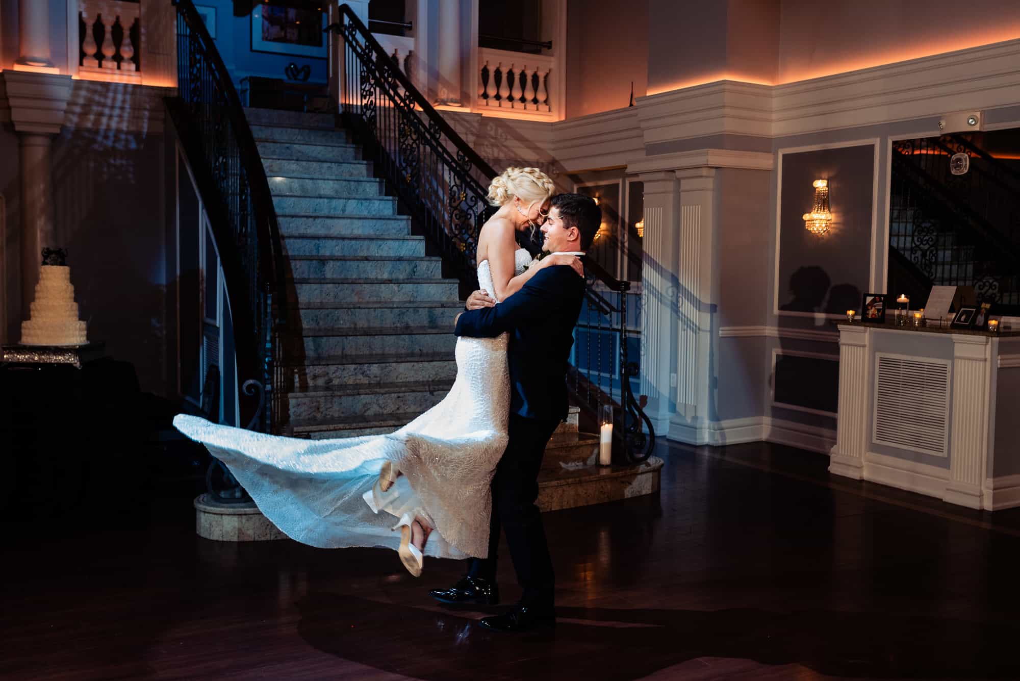 groom is lifting her bride at the arts ballroom