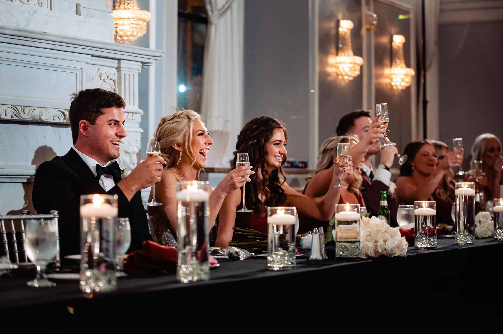 the newlyweds having a toast with the guests at the arts ballroom