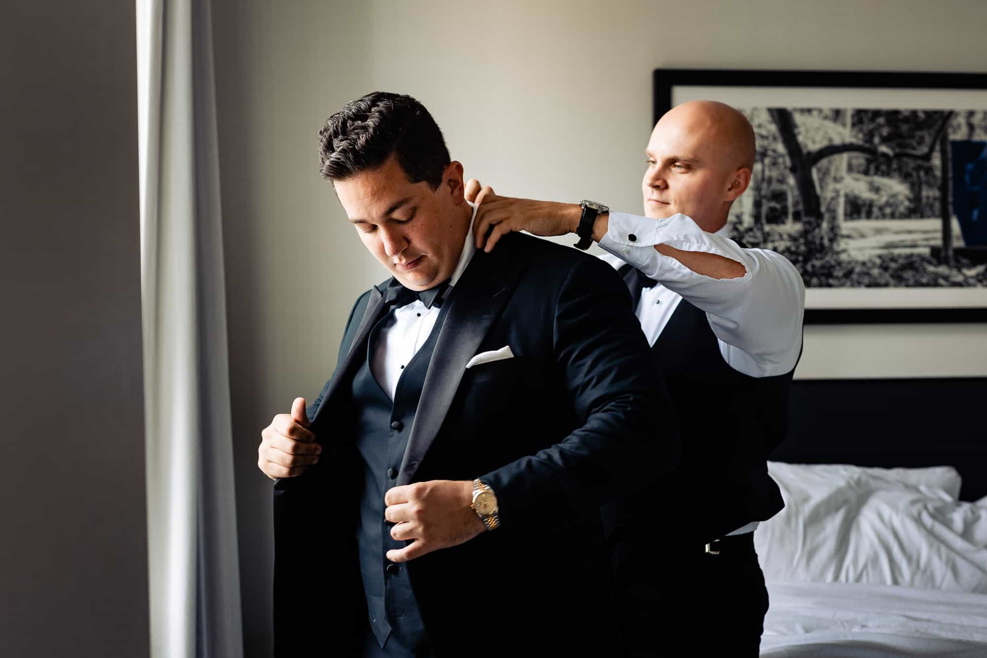 groom is assisted by his best man