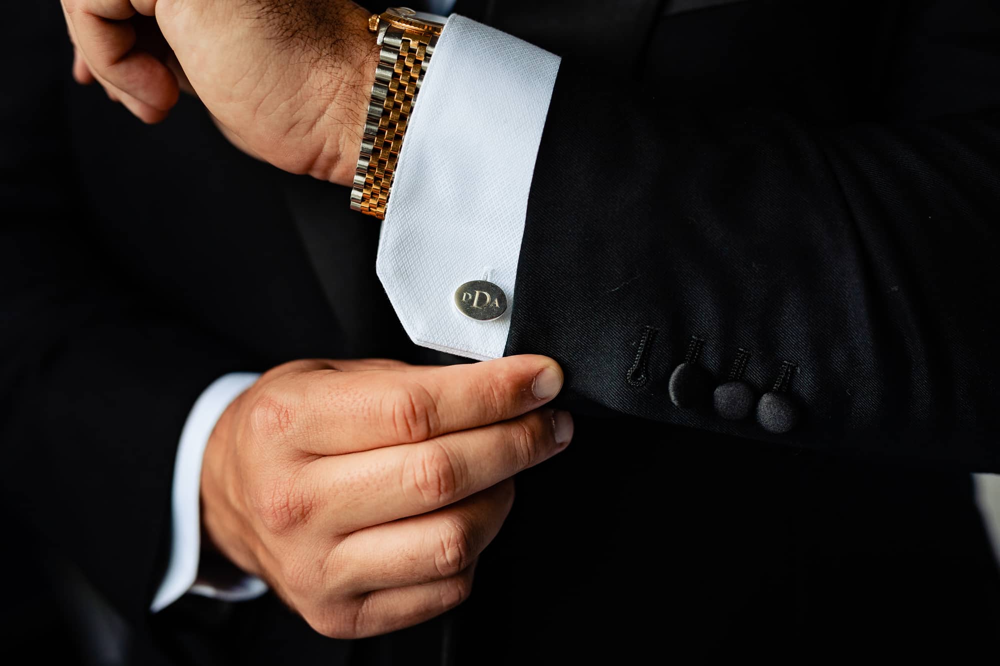 groom fixing his sleeve