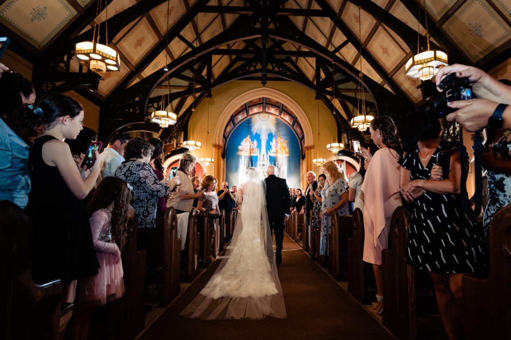 bride walking down the aisle with her father