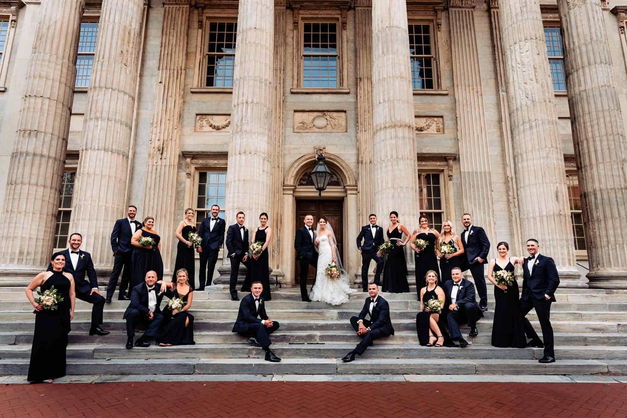 couple posing with the whole wedding entourage