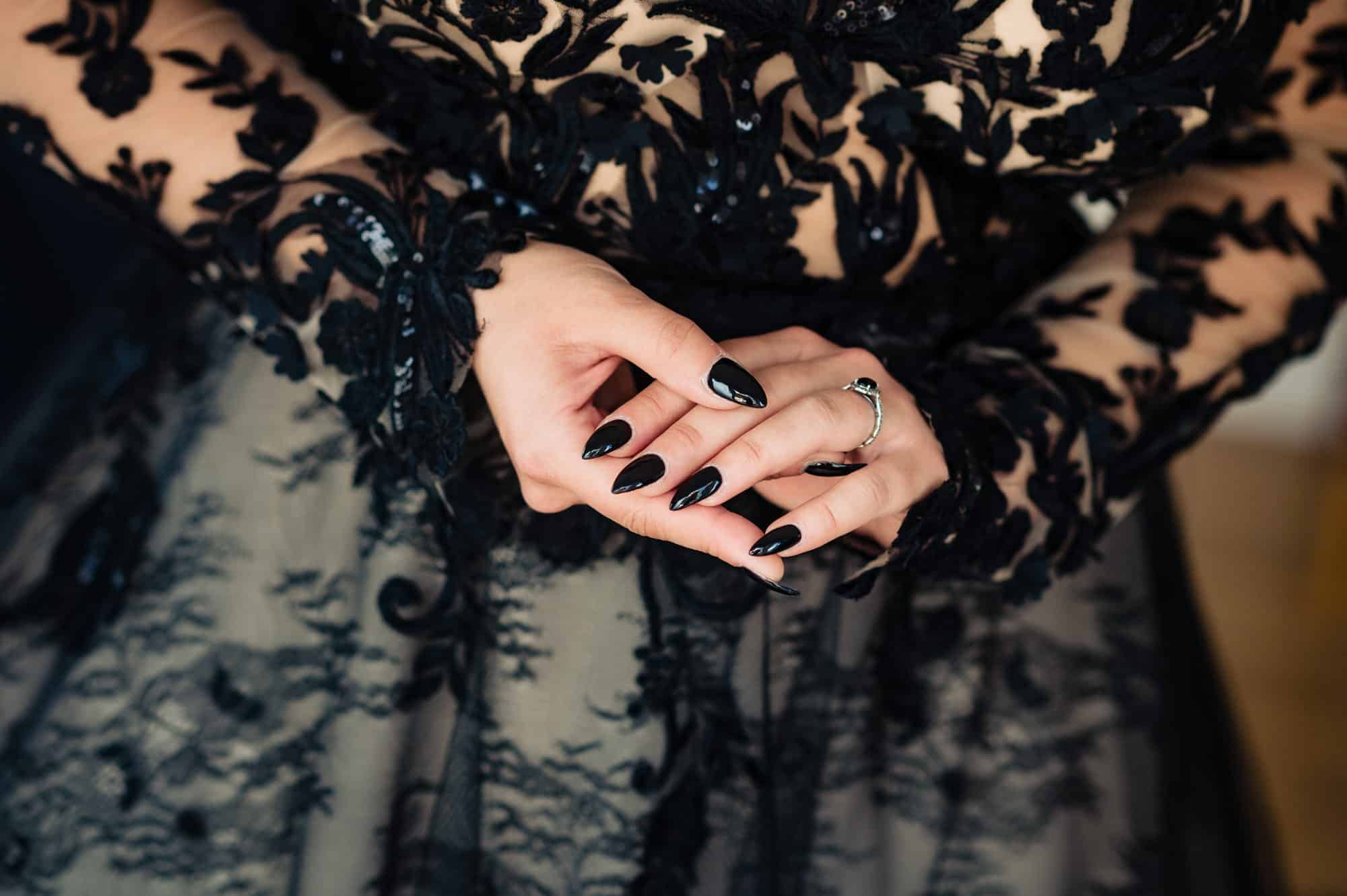 bride's hand wearing her black engagement ring