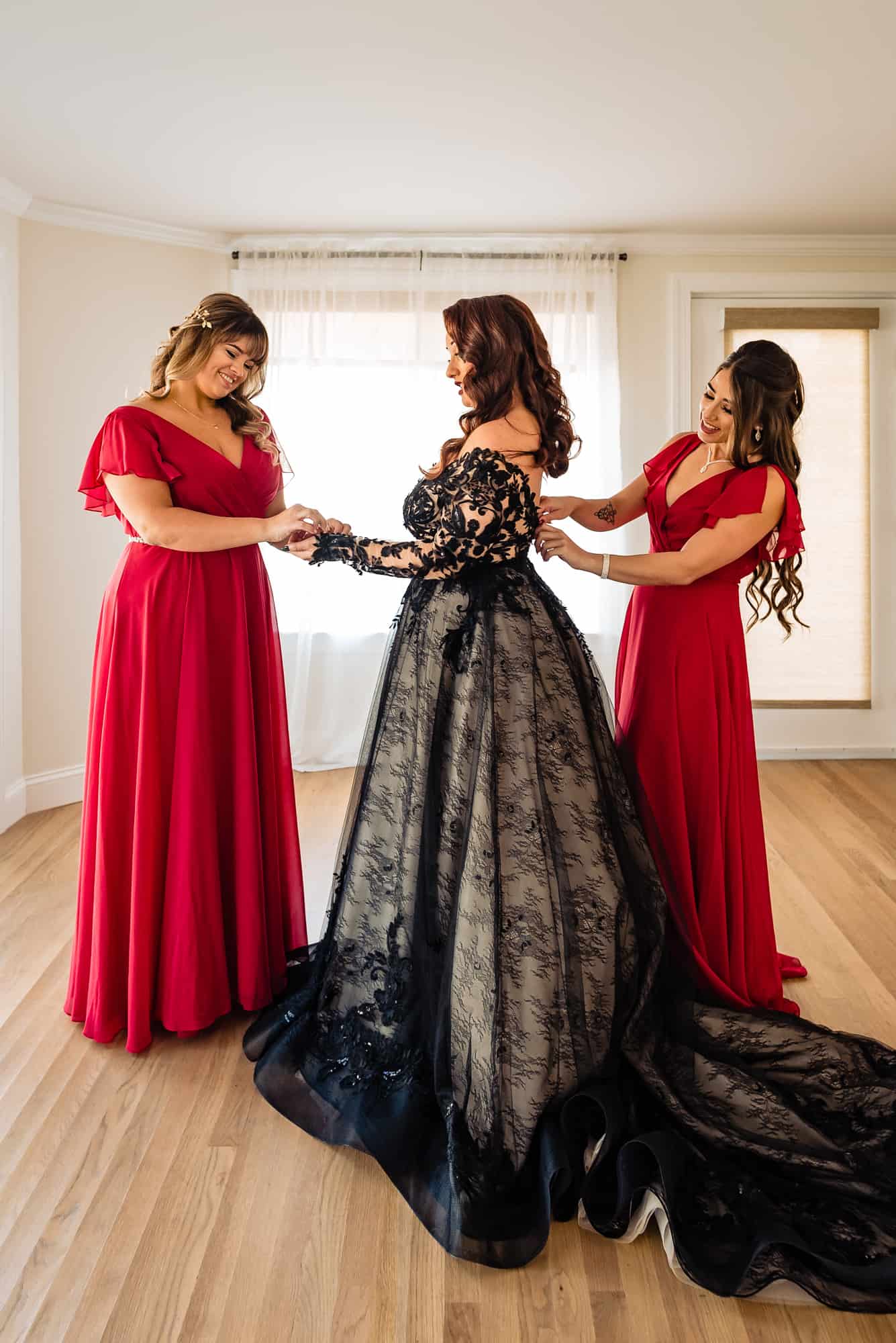 Bride getting ready with the help of her two bridesmaids