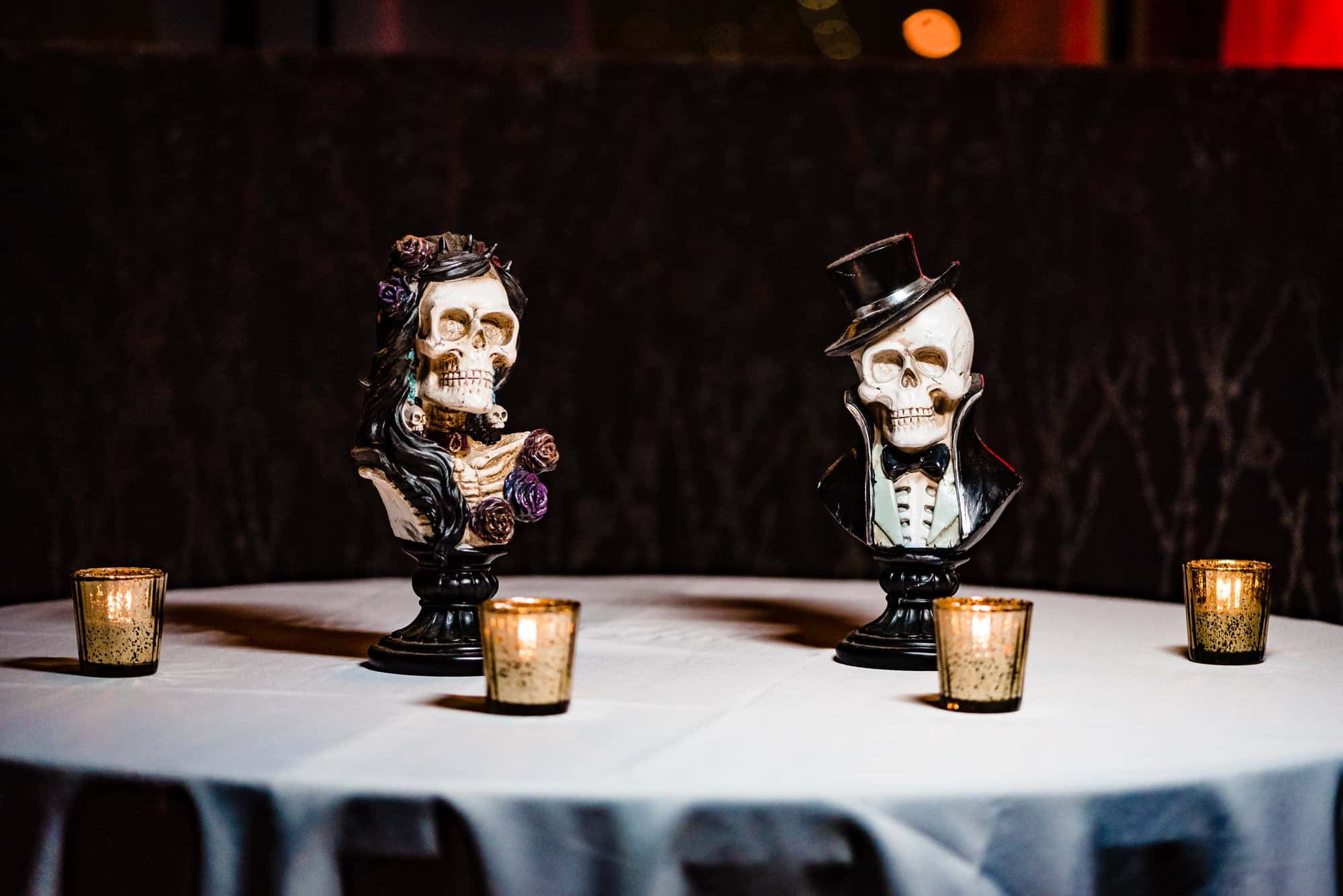 reception table setting featuring skeleton figures in black and white suits