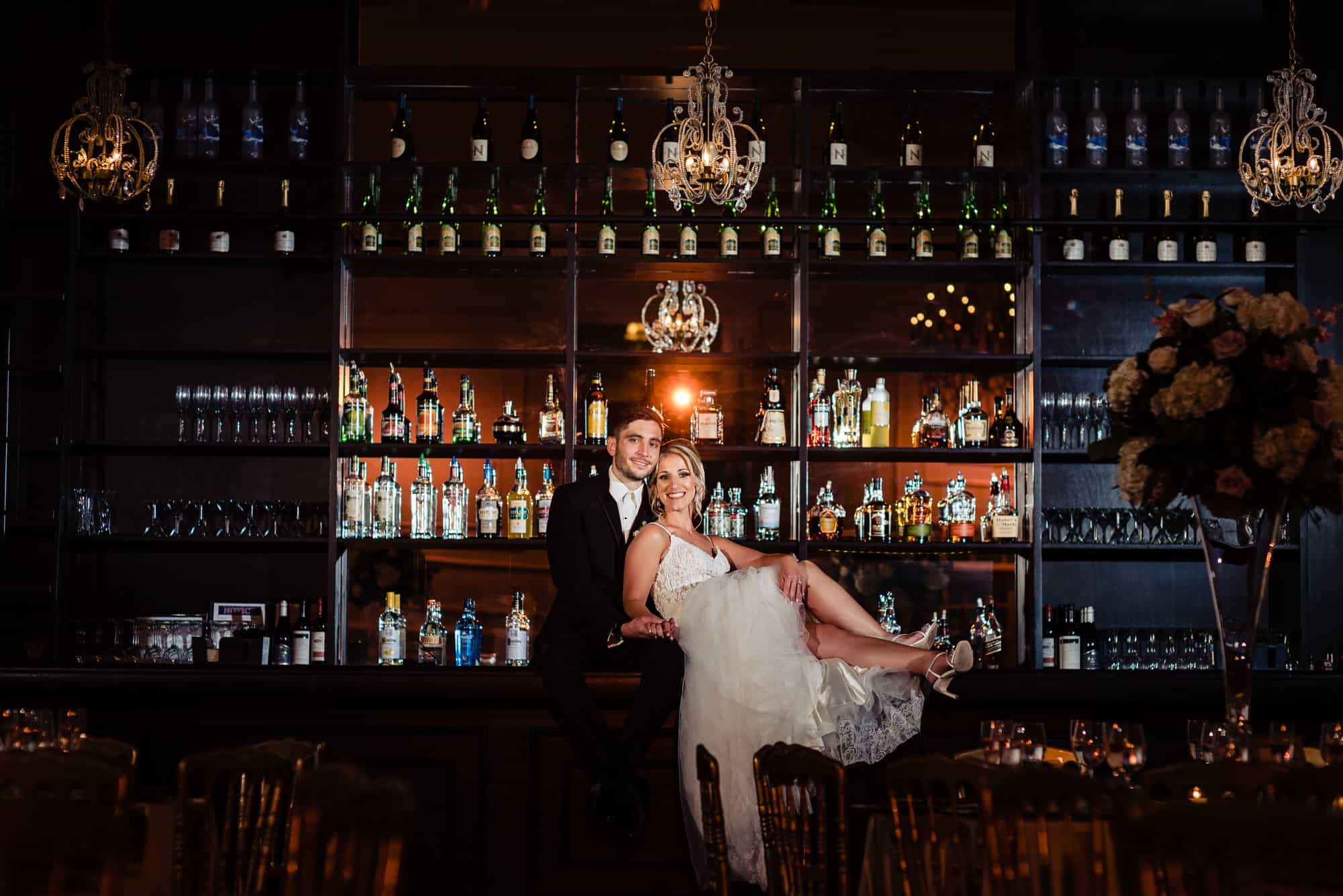 bride and groom taking a pose at the Cescaphe's bar area