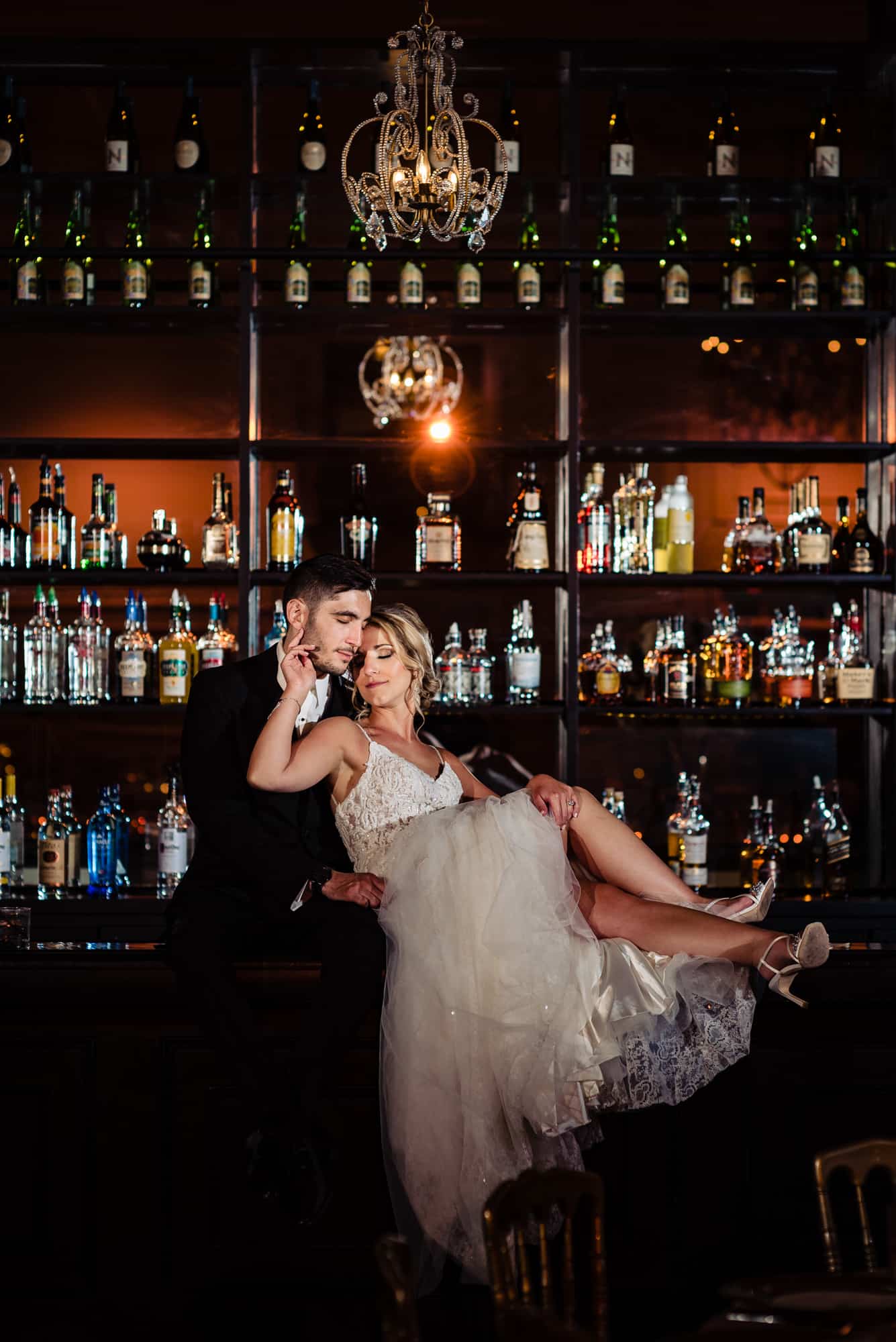 bride and groom taking a pose at the Cescaphe's bar area