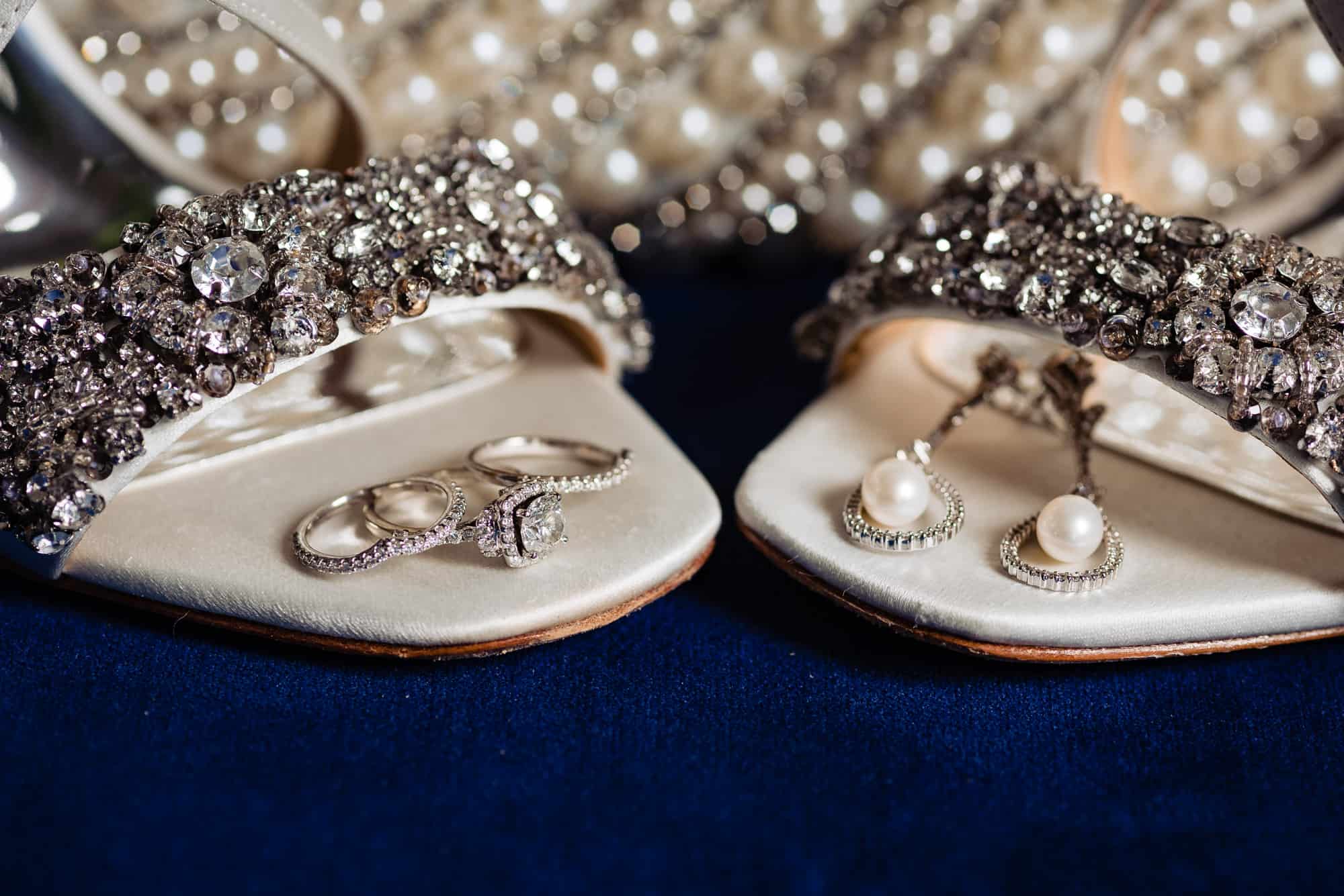 crystal encrusted wedding shoes and a pair of pearl earrings