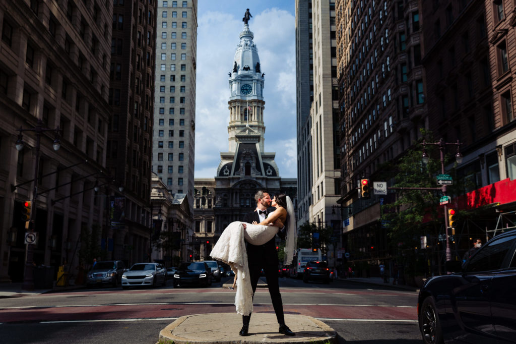 couple doing a lover's carry in the middle of the street