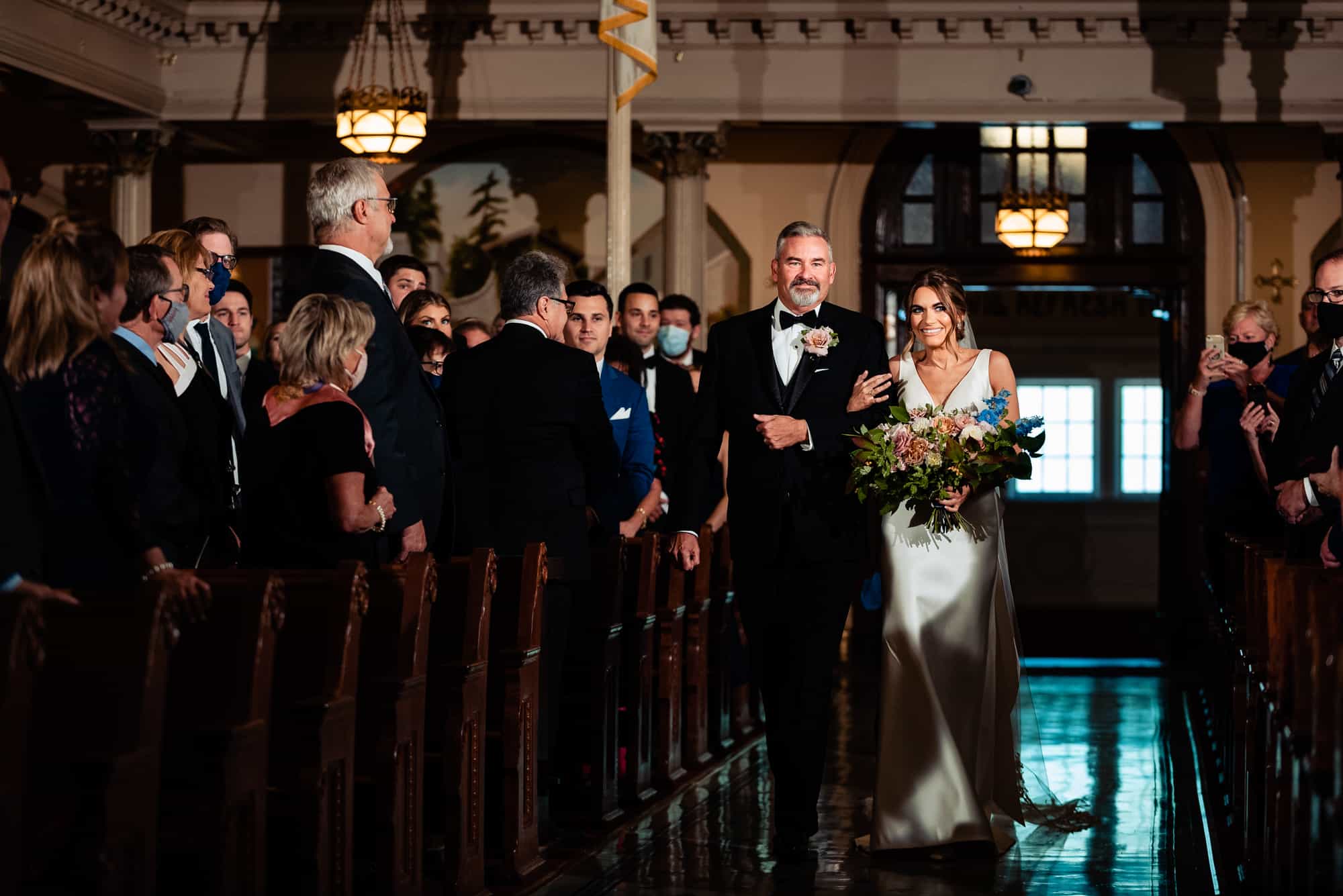 bride walking down the aisle with her father