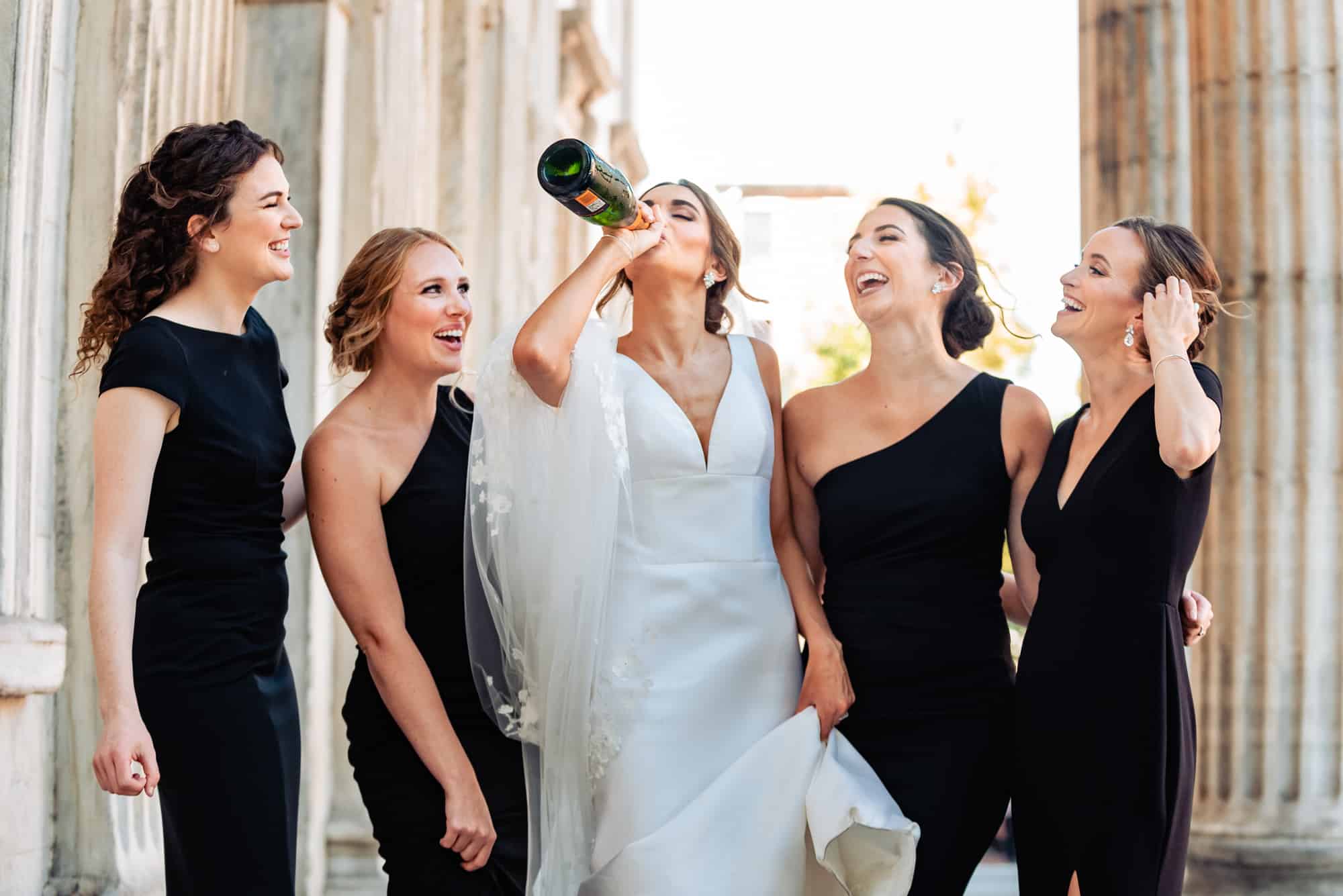 bride drinking champagne from the bottle