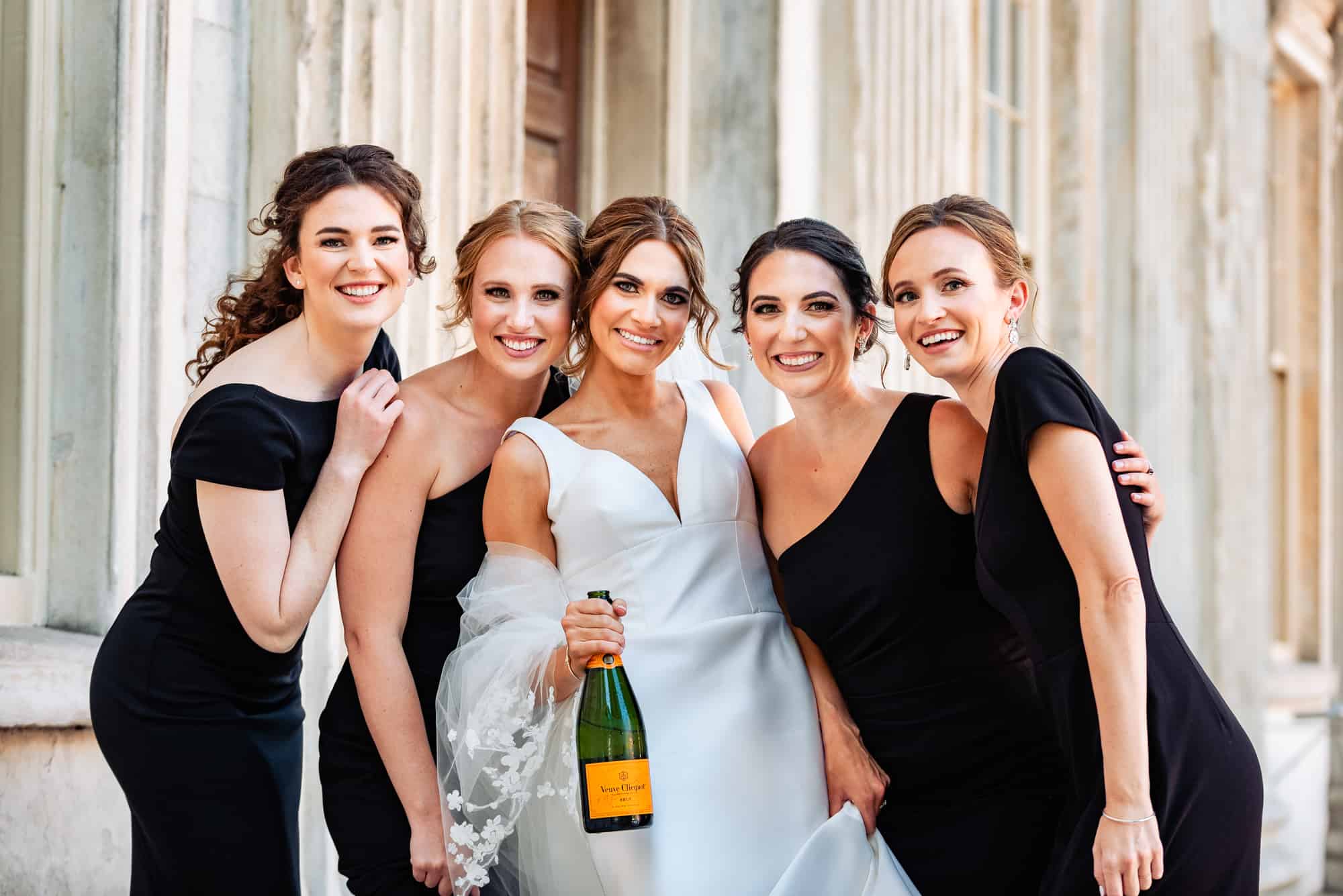 bride posing with her bridesmaids