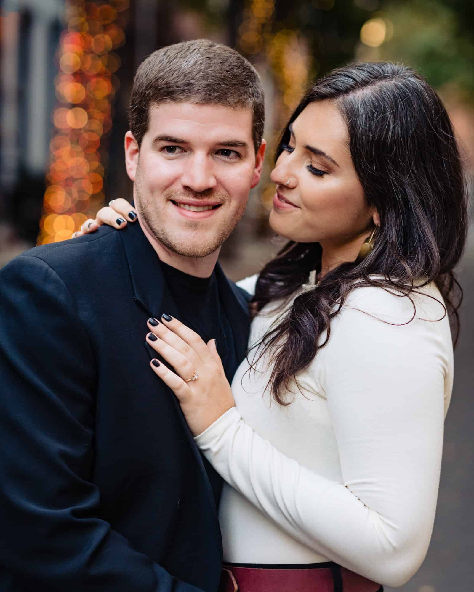 couple is taking a pose for their e-session at center city philly