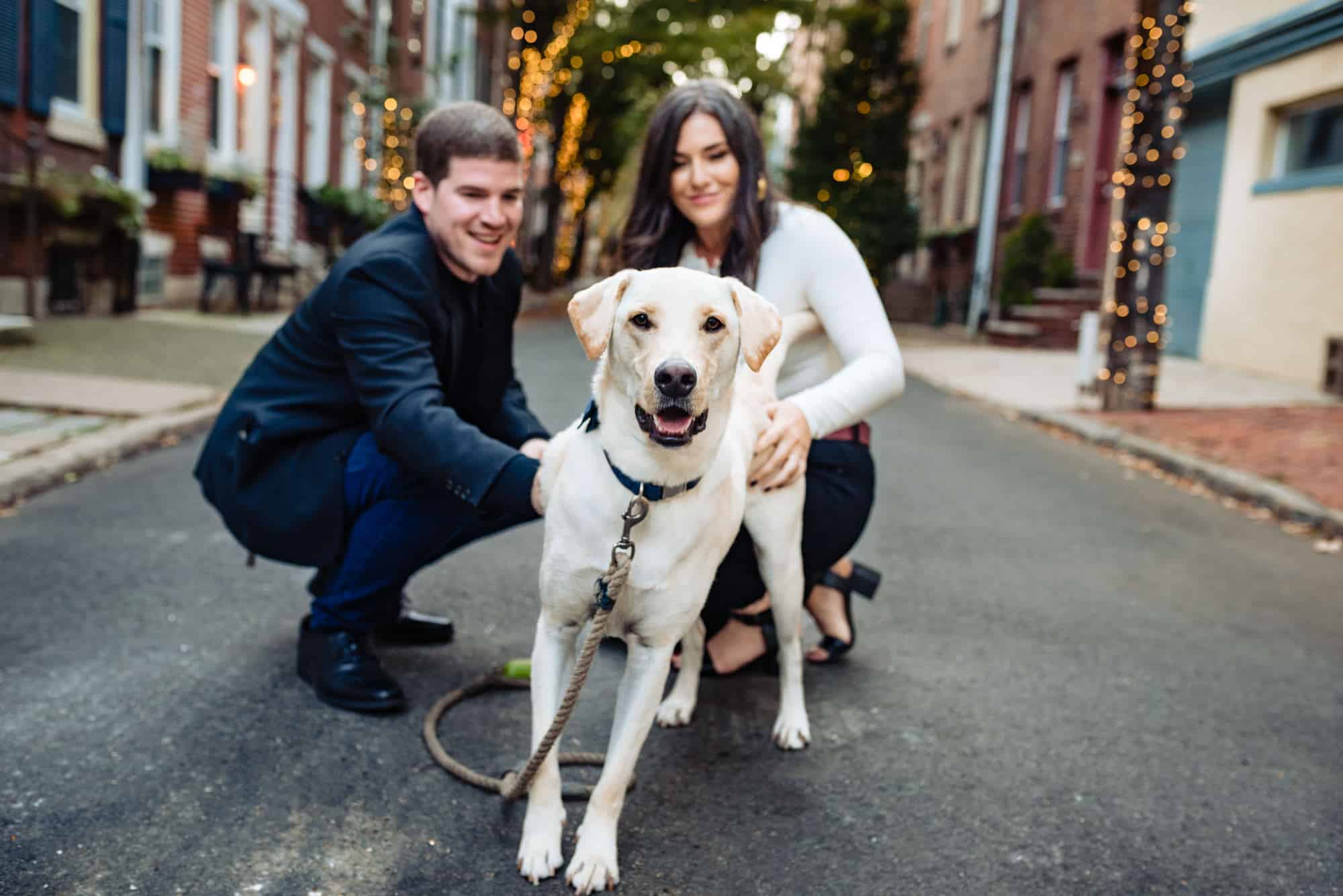 couple posing with their dog during their center city philly e-session