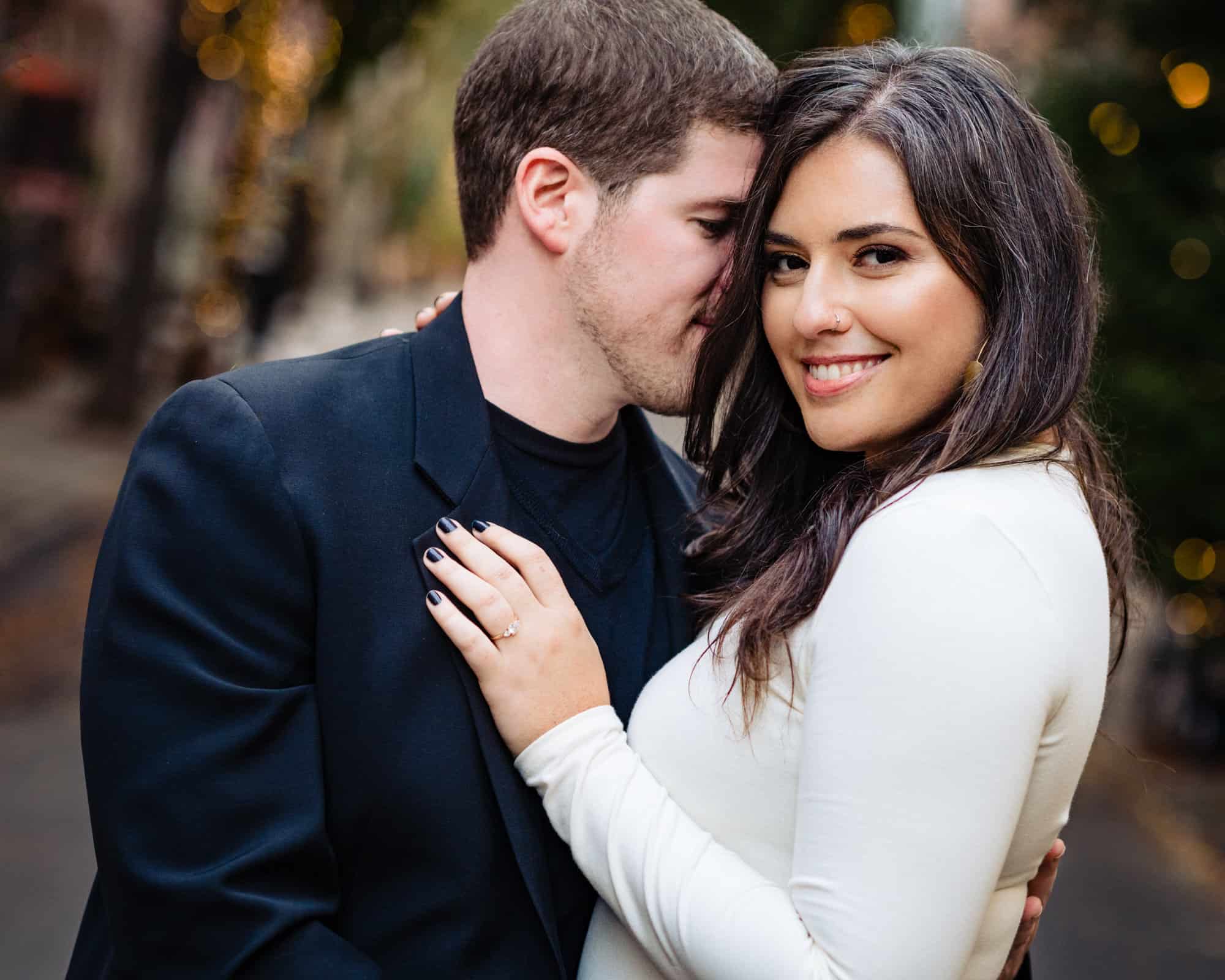 couple is taking a pose for their e-session at center city philly