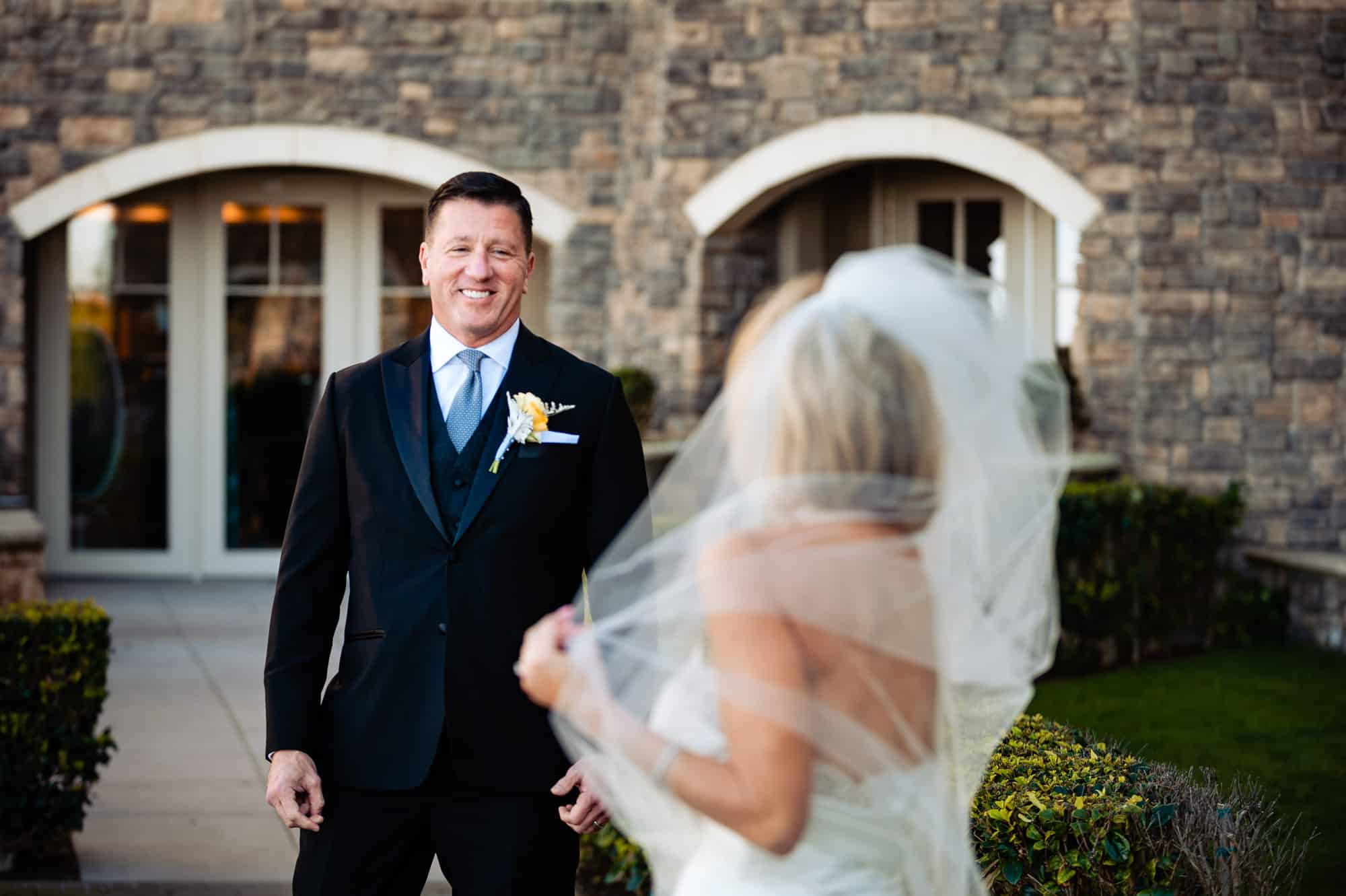 groom smiling at bride for the first look at Ritz-Carlton Half Moon Bay