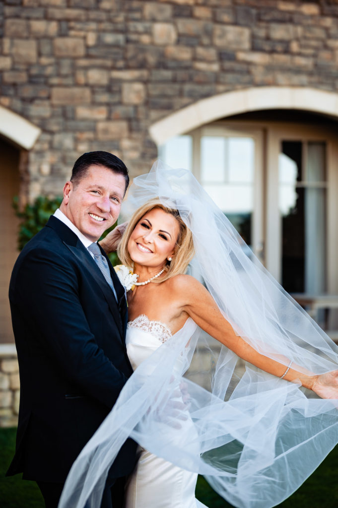 smiling couple before the wedding outside the Ritz-Carlton Half Moon Bay