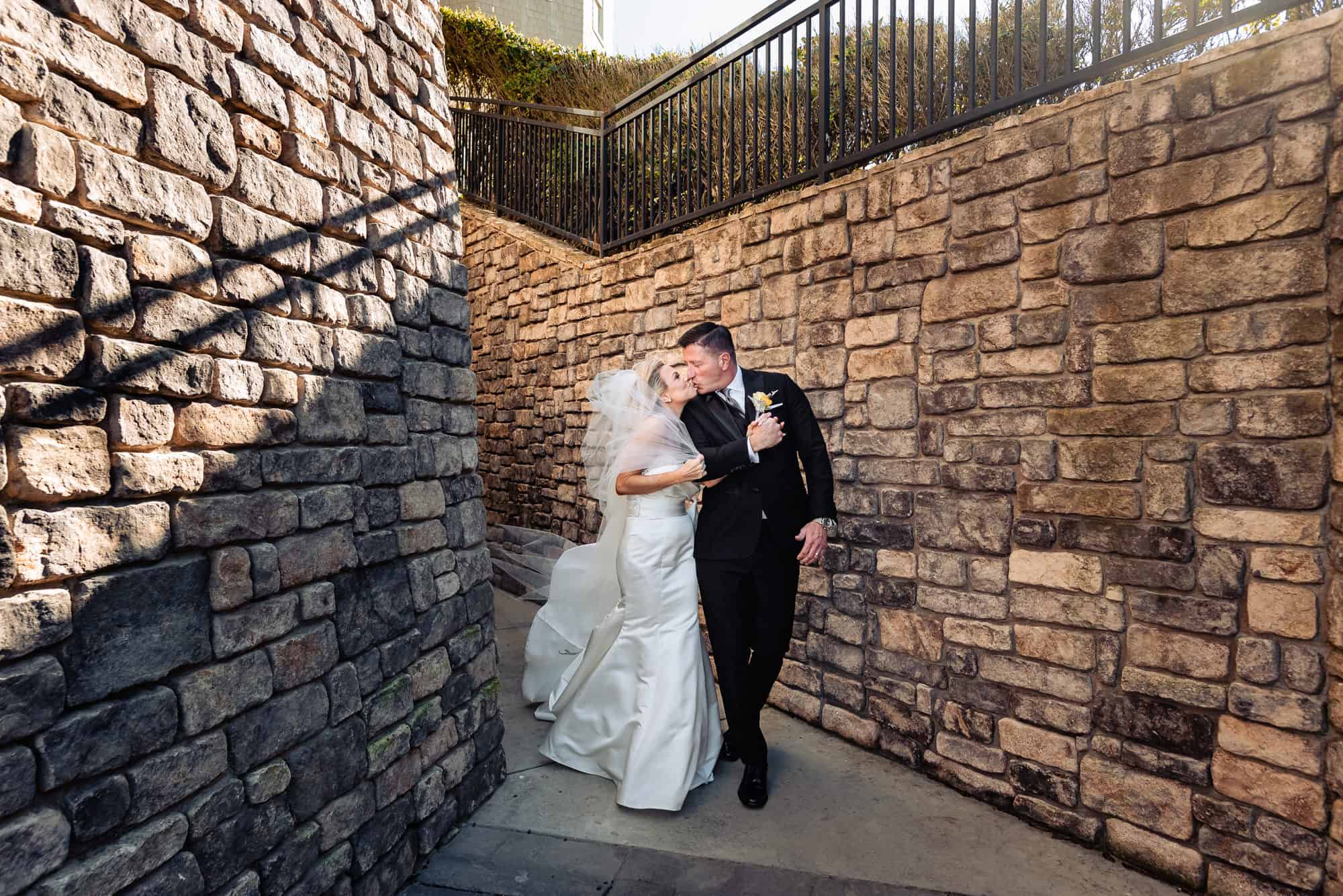 couple kissing before the wedding outside the Ritz-Carlton Half Moon Bay